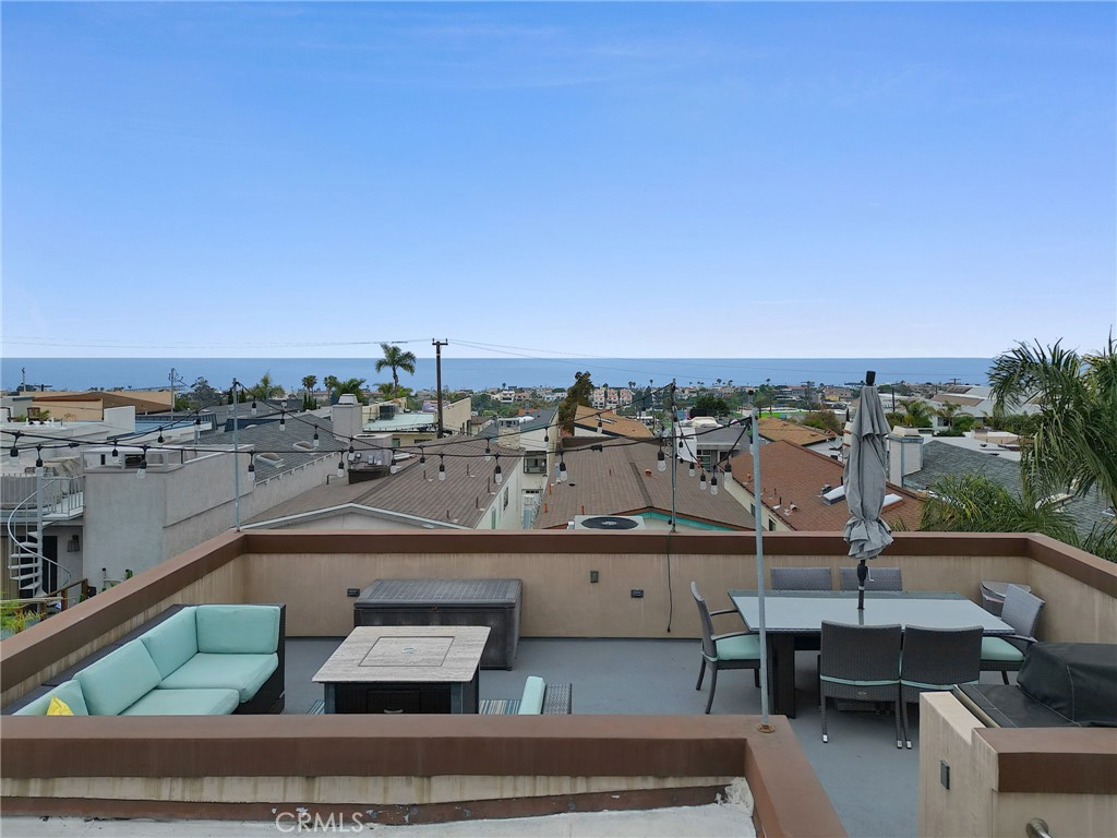 Experience the ultimate in coastal living with this stunning residence, perfectly situated on a rare oversized lot of nearly 4k sq ft in the heart of Hermosa Beach. Spanning approximately 2,500 sq ft of thoughtfully designed living space, this home offers an unparalleled blend of style, comfort, and functionality—along with some of the most breathtaking panoramic views on the coast. Take in 360° vistas from the expansive rooftop deck, showcasing the entire bay—from the Palos Verdes Peninsula and Catalina Island, past Malibu, and all the way to the skyline of downtown Los Angeles. Inside, the open-concept main level features bright, airy living areas with seamless indoor-outdoor flow. A cozy family room opens to a serene backyard complete with a built-in fire pit—perfect for relaxing or hosting. The flexible fourth bedroom on the main level is ideal for guests, a home office, or creative space. Upstairs, you'll find three generously sized bedrooms and a second private deck ideal for catching the ocean breeze. The Primary bedroom is spacious with ocean views, a luxurious ensuite bathroom with spa like tub, dual sinks and 2 closets. The gourmet kitchen is a chef’s dream, outfitted with top-of-the-line Thermador appliances, sleek finishes, and abundant storage. Three beautifully appointed bathrooms and a dedicated laundry room add convenience and comfort. Additional features include central A/C, tankless water heater, a spacious 2-car garage, and an extra-wide carport that accommodates at least four vehicles—an incredible asset in this beachside neighborhood. Just a short stroll to award-winning Hermosa Beach schools, parks, shops, and the sand, this home offers a rare opportunity to own a modern coastal retreat in one of Southern California’s most desirable communities.