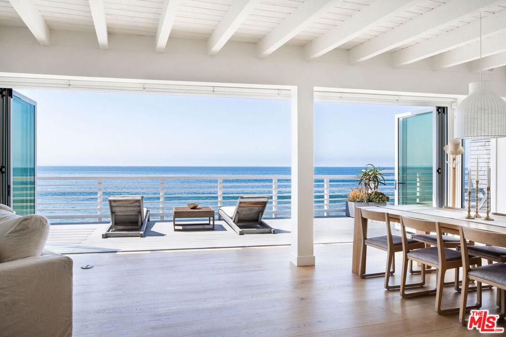 Welcome to 19706 Pacific Coast Highway, a beautifully updated traditional-style home perfectly positioned on the water featuring 55-feet of beach frontage and rare, direct beach access. Offering 3 ensuite bedrooms and 3 bathrooms, this residence combines classic coastal charm with modern comfort. From the moment you step inside, you're greeted by a dramatic panorama of the Pacific Ocean and the soothing soundtrack of waves crashing below. Folding glass doors open entirely to a spacious oceanfront deck, placing you directly over the water and creating a seamless indoor-outdoor flow for entertaining or relaxing. On this floor, you have an updated kitchen, dining area, living room with gas burning fireplace and two ensuite bedrooms. Upstairs, the entire primary suite serves as a serene retreat, complete with a large sitting area, expansive bedroom, walk-in closet, and a spa-inspired bathroom. Wake up to panoramic ocean vistas and fall asleep to the sound of the surf. Additional features include a 2-car garage, direct stair access to the beach and storage below the house. Whether as a full-time home, weekend getaway, or investment, this property offers the ultimate Malibu lifestyle--sun, surf, and sunsets--at an unbeatable value under $5M.