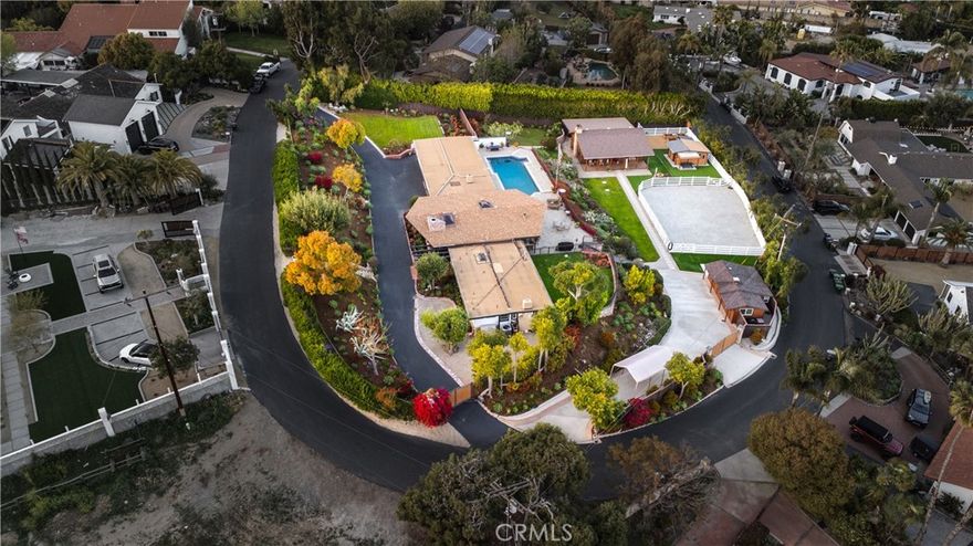 Welcome home to your very own mini-ranch in the beautiful, private equestrian neighborhood of Spotted Bull.  This custom built, fully gated property boasts the best elevation, views and lot utility in the neighborhood.  Situated on 1 acre and fully fenced with custom entrance, exit and pedestrian gates, the expansive grounds invite you in featuring many varieties of native flowering plants, fruit trees and expansive lawn areas.  The single level home opens to vaulted open beam ceilings, walls of windows, a custom river stone fireplace with limestone mantel, hardwood flooring and a large family kitchen to host multiple gatherings in style.  The spacious family room with built-in bookcases, cabinets and bench seat is a great place to gather and relax, including a see-through fireplace connecting the family room with the kitchen. The large backyard includes an oversized swimming pool, spa, firepit, panoramic views of the hills and plenty of room to  host large parties or just relax and enjoy the scenery.  The lower portion of the property has an enchanting cedar log cabin approximately 780 sf. featuring 2 Bedrooms and 1 bathroom, an inviting front and rear covered porch, detached office and storage space, raised garden beds, firepit and fenced arena with 2 gated entrances and RV access.  At the end of the walkway you will find the “bunkhouse”, a former converted barn, offering more office and storage space and a great place for the teens to hang out. This property is perfect for multi-generational needs, with potential for SB-9 lot splits and numerous development opportunities. This one of a kind property is located near award winning schools, multiple scenic hiking and riding trails, charming downtown San Juan Capistrano with popular shops, restaurants, the Mission and Los Rios Historic District with easy access to Doheny Beach, Dana Point Harbor and all that southern California has to offer.