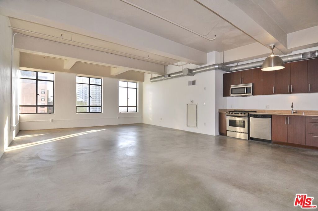 Perfect live/work studio loft on the 10th floor at the iconic Eastern Columbia building. This 900sf loft with amazing unobstructed south facing views gets an abundance of natural light through massive vintage windows. The loft features tall ceilings, concrete floors, an open floorplan for your creative needs. There is a large closet near the bathroom with a stacked washer and dryer. The Kelly Wearstler designed bathroom features a soaking tub. 1 garage parking space is included in the rent! The Eastern Columbia has a beautiful rooftop pool, sun deck, spa, and fitness center with breathtaking views of DTLA, designer lobby with a 24/7 reception desk and security, courtyard, dog area, and attached parking garage. Within blocks to everything including Whole Foods, Fashion District, Orpheum, Proper and Hoxton hotels, Metro, The Broad, IL Caffe, Cliftons, Caldo Verde, Zinque, Walt Disney Concert Hall, The Bloc, Fashion District, City Market South, Grand Central Market, and more.