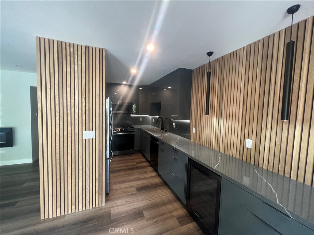 Stunning, renovated 2 BR 2 BA unit in Sherman Oaks. Remodeled kitchen includes newer custom cabinets, counters, and appliances (including wine refrigerator). Kitchen opens to dining area and spacious living room with electric fireplace and sliding door to balcony. Two en-suite rooms feature custom closets and baths with designer tilework. Completed with modern accents such as custom doors and woodwork and designer lighting. Located with convenient access to the 101, 405, Sepulveda Blvd., and in close proximity to the Sherman Oaks Galleria.