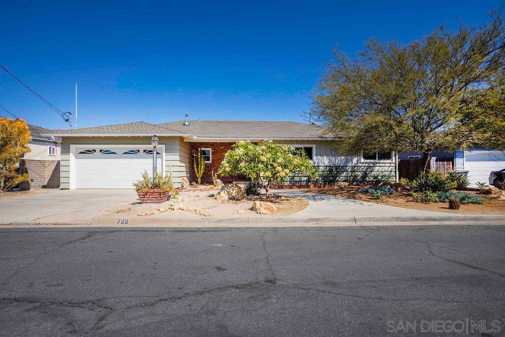 Welcome to this beautifully updated, single-level 1950s ranch-style home located on a double cul-de-sac with no through traffic! Step inside where you are greeted with large picture windows, stylish block glass and views of the surrounding neighborhoods. The heart of the home is the expansive great room & kitchen. The kitchen was completely remodeled and custom designed by Lars Construction. This thoughtfully designed space features vaulted ceilings, rich cabinetry, granite countertops, a generous center island, pendant and undermount lighting—perfect for entertaining or everyday living. See supplement for additional upgrades! Hardwood floors flow through out the home, complemented by custom built-ins and quality finishes. Notable upgrades include Milgard windows, sliders and French door that open to the patio. Upgraded 200-amp panel and electrical wiring, skip-troweled walls and ceilings, canned lighting, barn door, fresh interior paint, a tankless water heater, AC and a sleek epoxy-coated garage floor. The backyard offers a covered patio and a terraced lot accented with a mature plumeria plant, hibiscus and succulents. This move-in-ready gem is combined with timeless, vintage touches with modern conveniences in a highly desirable location! Close to highway 125, grocery stores & Grossmont College.