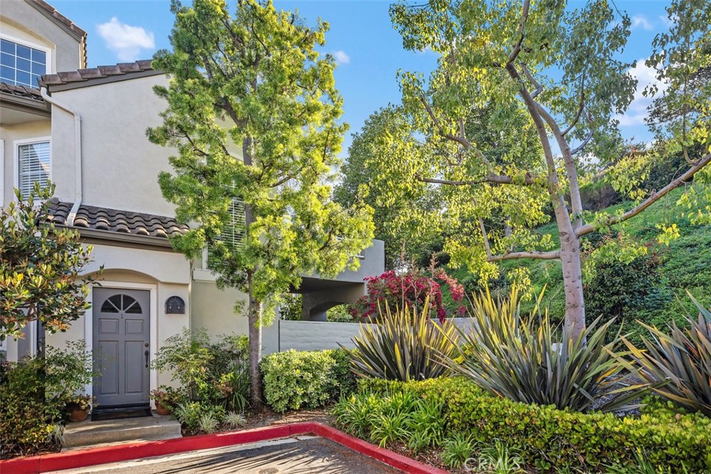 Beautiful corner unit in highly desirable Villas North, Aliso Viejo! This unique condo is one of the few in the community with amazing views of the green belt. Features include an open floor plan, a custom slate gas fireplace with fire glass, and wood-look vinyl flooring in the kitchen and bathrooms. Step out to a spacious private patio with tranquil views of trees and the hillside, perfect for relaxing! The kitchen offers honed granite countertops, stainless steel appliances, a new backsplash, and direct access to the oversized 2-car garage with laundry hook-ups and built-in storage. Recent upgrades include a new sliding patio door, dishwasher, microwave, garage door opener, faucets, garbage disposal, switches, plugs, door handles, and a stylish sliding barn door for the primary bathroom. The primary suite includes a walk-in closet and an en-suite bathroom with a beautiful glass mosaic tile shower. A third-story loft provides a flexible space ideal for a home office, guest room, or additional living area. Located just down the road from Aliso Viejo Middle School and close to parks, hiking trails, and Aliso Town Center with shopping, dining, and entertainment. Don’t miss this rare opportunity to own a move-in ready home in one of Aliso Viejo’s most desirable neighborhoods!