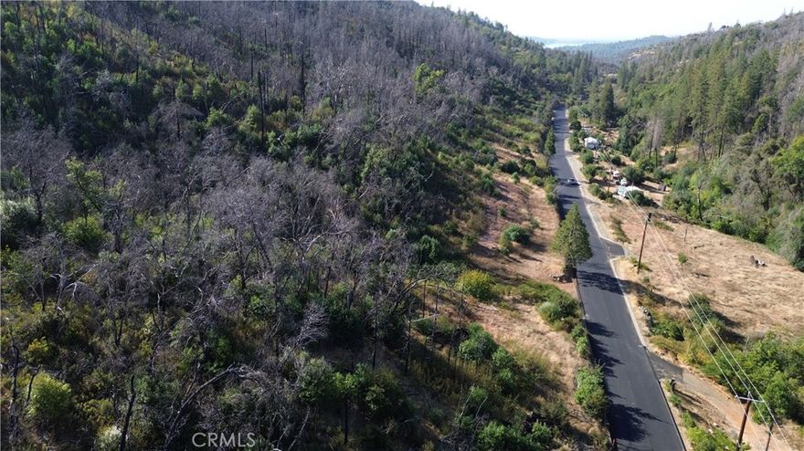 Discover the ultimate canvas for your dream property on this expansive 32+ acre parcel offering unmatched privacy and natural beauty. Nestled among mature trees with charming clearings scattered throughout, this secluded land provides endless possibilities for those seeking a peaceful escape or recreational haven.
The elongated parcel borders the highway with multiple access points, making it exceptionally convenient to reach several potential building sites throughout the property. This unique configuration offers flexibility for development while maintaining the privacy and tranquility of each location.
The property features potential water rights to the Berry Creek ditch (buyer to verify), adding significant value for future development or agricultural use. Two building sites previously existed on the land prior to the wildfire that affected the Berry Creek area.
Whether you envision building your custom home, creating a family compound, or developing a recreational retreat, this rare offering provides the space and privacy to bring your vision to life.