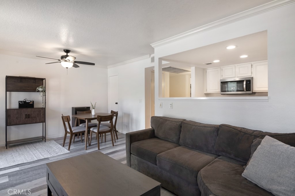 Welcome Home! Freshly updated and move-in ready, this upper-level condo shines with new appliances (stove, microwave, dishwasher, disposal, and A/C), newer flooring, and wood shutters throughout. The bright kitchen features white cabinetry and opens to a spacious living and dining area, leading out to a large private balcony. The roomy bedroom offers dual closets, and the bathroom has been modernized with a sleek vanity and updated fixtures. Additional highlights include in-unit laundry hook-ups, carport parking, and a well-kept, gated community with a pool, spa, and gym. Ideally located near local schools, markets, and dining, this home delivers comfort, style, and convenience — a perfect place to call your own! Come check it out today!