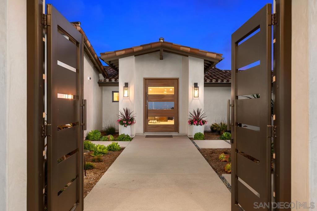 Completely rebuilt in 2021, this extraordinary, single-level Modern Spanish residence boasts a breathtaking design aesthetic, rare 6-car garage, serene cul-de-sac locale, and dazzling day-to-night views of the ocean, bay, downtown skyline & city lights. Tucked upon a 0.48-acre parcel, you’re greeted by a manicured front yard, walled and gated entry courtyard with a fountain, and a striking pivot door leading into the ultra-appealing, light-filled interior. The thoughtfully designed, open-concept floor plan showcases a spectacular great room with the added benefit of a concealed butler’s pantry allowing for seamless entertaining and immaculate living. The chef’s kitchen offers abundant cabinetry, an expansive Neolith island & counters, gorgeous marble backsplash, walk-in pantry, and stainless appliances including 4 Wolf ovens, 2 KitchenAid dishwashers, 2 Sub-Zero refrigerators & wine cooler. The luxe master retreat, privately situated away from the 4 secondary bedrooms, has a spacious walk-in closet, marble bath with soaking tub & oversized shower, and southerly views overlooking the pool patio and beyond. The smart home system integrates the lighting, music, televisions, cameras & climate control. Enjoy soothing coastal breezes in the tranquil backyard with a color-changing pool and spa with water features plus a generous patio with a fire pit ideal for lounging. Additional amenities: solar for the house & pool, 3 independent HVAC systems with individual thermostats in each bedroom, garage wiring for EV charging stations, indoor-outdoor surround sound, and more. A must see! Completely rebuilt in 2021, this extraordinary, single-level Modern Spanish residence boasts a breathtaking design aesthetic, rare 6-car garage, serene cul-de-sac locale, and dazzling day-to-night views of the ocean, bay, downtown skyline and city lights. Tucked upon a 0.48-acre parcel, you’re greeted by a manicured front yard, walled and gated entry courtyard with a fountain, and a striking pivot door leading into the ultra-appealing, light-filled interior. The thoughtfully designed, open-concept floor plan showcases a spectacular great room with the added benefit of a concealed butler’s pantry allowing for seamless entertaining and immaculate living. As distinctive as it is functional, the chef’s kitchen offers abundant cabinetry, an expansive Neolith-topped island and counters, gorgeous marble backsplash, walk-in pantry, and stainless appliances including 4 Wolf ovens, 2 KitchenAid dishwashers, 2 Sub-Zero refrigerators & wine cooler. The luxe master retreat, privately situated away from the 4 secondary bedrooms, has a spacious walk-in closet, marble bath with soaking tub and oversized shower, and southerly views overlooking the pool patio and beyond. The highly programmable smart home system integrates the lighting, music, televisions, cameras and climate control. A car enthusiast’s dream, the 6-car garage has built-in storage and is wired on each side for EV charging stations. Enjoy warm coastal breezes in the tranquil backyard boasting a color-changing pool and spa with water features, and a generous patio with a fire pit ideal for lounging. Additional amenities include solar power for the house and pool, 3 independent HVAC systems with individual thermostats in each bedroom, indoor-outdoor surround sound, and so much more. This La Jolla Alta Beauty is a must see! Equipment: Garage Door Opener,Pool/Spa/Equipment, Range/Oven Sewer: Sewer Connected Topography: GSL,SSLP