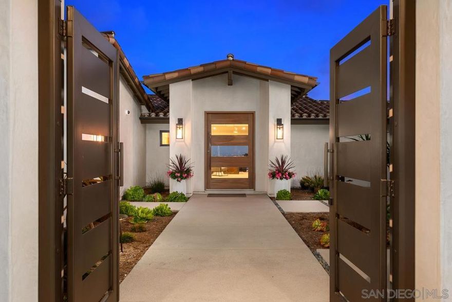 Completely rebuilt in 2021, this extraordinary, single-level Modern Spanish residence boasts a breathtaking design aesthetic, rare 6-car garage, serene cul-de-sac locale, and dazzling day-to-night views of the ocean, bay, downtown skyline & city lights. Tucked upon a 0.48-acre parcel, you’re greeted by a manicured front yard, walled and gated entry courtyard with a fountain, and a striking pivot door leading into the ultra-appealing, light-filled interior. The thoughtfully designed, open-concept floor plan showcases a spectacular great room with the added benefit of a concealed butler’s pantry allowing for seamless entertaining and immaculate living. The chef’s kitchen offers abundant cabinetry, an expansive Neolith island & counters, gorgeous marble backsplash, walk-in pantry, and stainless appliances including 4 Wolf ovens, 2 KitchenAid dishwashers, 2 Sub-Zero refrigerators & wine cooler. The luxe master retreat, privately situated away from the 4 secondary bedrooms, has a spacious walk-in closet, marble bath with soaking tub & oversized shower, and southerly views overlooking the pool patio and beyond. The smart home system integrates the lighting, music, televisions, cameras & climate control. Enjoy soothing coastal breezes in the tranquil backyard with a color-changing pool and spa with water features plus a generous patio with a fire pit ideal for lounging. Additional amenities: solar for the house & pool, 3 independent HVAC systems with individual thermostats in each bedroom, garage wiring for EV charging stations, indoor-outdoor surround sound, and more. A must see!  Completely rebuilt in 2021, this extraordinary, single-level Modern Spanish residence boasts a breathtaking design aesthetic, rare 6-car garage, serene cul-de-sac locale, and dazzling day-to-night views of the ocean, bay, downtown skyline and city lights. Tucked upon a 0.48-acre parcel, you’re greeted by a manicured front yard, walled and gated entry courtyard with a fountain, and a striking pivot door leading into the ultra-appealing, light-filled interior. The thoughtfully designed, open-concept floor plan showcases a spectacular great room with the added benefit of a concealed butler’s pantry allowing for seamless entertaining and immaculate living. As distinctive as it is functional, the chef’s kitchen offers abundant cabinetry, an expansive Neolith-topped island and counters, gorgeous marble backsplash, walk-in pantry, and stainless appliances including 4 Wolf ovens, 2 KitchenAid dishwashers, 2 Sub-Zero refrigerators & wine cooler. The luxe master retreat, privately situated away from the 4 secondary bedrooms, has a spacious walk-in closet, marble bath with soaking tub and oversized shower, and southerly views overlooking the pool patio and beyond. The highly programmable smart home system integrates the lighting, music, televisions, cameras and climate control. A car enthusiast’s dream, the 6-car garage has built-in storage and is wired on each side for EV charging stations. Enjoy warm coastal breezes in the tranquil backyard boasting a color-changing pool and spa with water features, and a generous patio with a fire pit ideal for lounging. Additional amenities include solar power for the house and pool, 3 independent HVAC systems with individual thermostats in each bedroom, indoor-outdoor surround sound, and so much more. This La Jolla Alta Beauty is a must see! Equipment: Garage Door Opener,Pool/Spa/Equipment, Range/Oven Sewer:  Sewer Connected Topography: GSL,SSLP