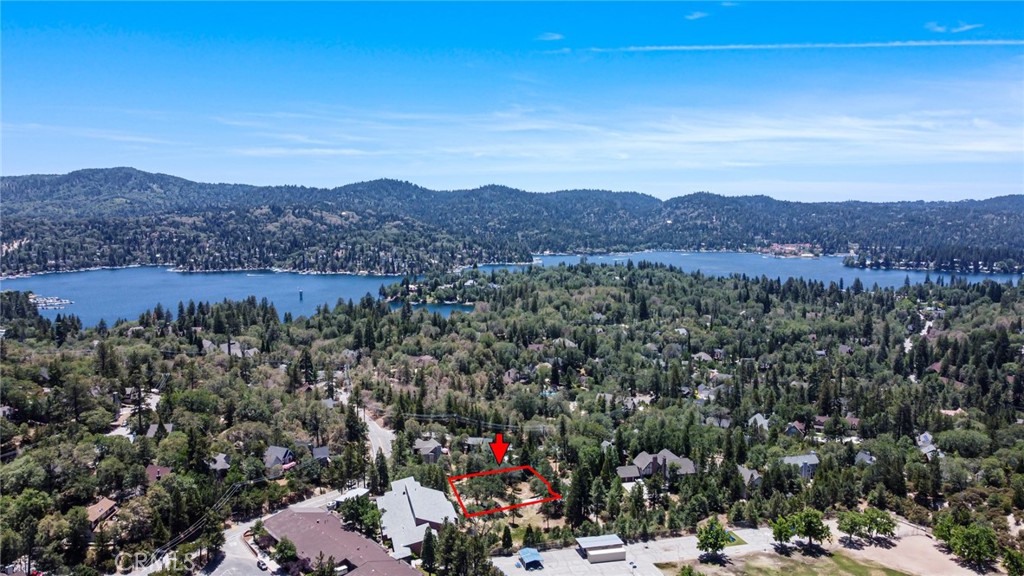 .36 ACRE. Amazing Vacant Lot! LAKE RIGHTS included! The adjacent lot is also for sale and shown in the pictures. Tucked away at the tranquil end of a quiet cul-de-sac lies a hidden gem. An untouched parcel gently sloping across a canvas of soft wild grasses. You can ensure relaxation on this serene mountain land. Peace is felt from hearing the soft rustle of leaves in the breeze. This haven offers a a perfect place to build a retreat, where the quiet hum of nature sings gently through open windows and time itself seems to slow. No passing thru traffic here. Just a 2 minute drive to Tavern Bay Beach Club. All utilities are available but not activated. Buyer is advised to do their due diligence.