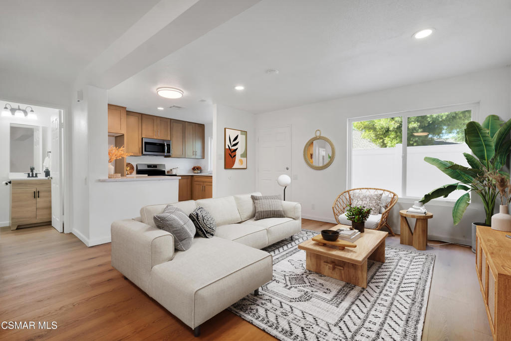 Welcome All Buyers to this Remodeled & Re-imagined 2-Bed, 1.5 Bath Condo with 2-car garage and low HOA Fees!! This Centrally located Meadowbrook condo offers 912 SF and has been tastefully renovated from top to bottom, including a sleek modern kitchen, updated bathrooms, gorgeous vinyl plank flooring, fresh paint, and brand-new windows throughout. The open-concept design seamlessly connects the spacious family and dining area to the updated kitchen, making it perfect for both entertaining and everyday living. Enjoy the warm neutral vinyl plank flooring throughout the lower level and new carpet upstairs. The Kitchen boasts quartz countertops, contemporary neutral cabinetry, stainless steel appliances, and an added island. Plus, a window over the sink offers a view of your outdoor private patio. Upstairs, you'll find two generously sized bedrooms with new mirrored closet doors and a full bath. The convenient half bath located downstairs is perfect for guests. The private patio offers newer vinyl fencing and a gate, which serves as your main entrance to the home. The community laundry and 2-car detached garage are just steps away from the unit. This complex is classified as a PUD (Planned Unit Development), not a traditional condo, which means all financing options are welcome!