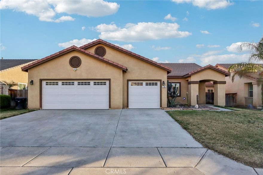 Single-story home with mountain views at the front and an owned solar system, offering bright living spaces and a functional, well-designed layout. Go inside to a welcoming living room filled with great natural light and finished with durable wood look ceramic tile flooring. The open kitchen and dining area feature tile flooring, a pantry for added storage, and a sliding glass door that opens directly to the backyard—perfect for indoor-outdoor living. The spacious backyard includes a covered patio ideal for relaxing, entertaining, or enjoying evening meals outdoors. The private primary suite offers a peaceful retreat with its own sliding glass door to the patio, a generous en suite bathroom complete with dual sink vanity, soaking tub, separate shower, and a walk-in closet. Two additional bedrooms and a full bathroom provide flexibility for guests, family, or a home office. Conveniently located at the end of the hallway, is a spacious laundry room and direct access to the 3-car garage—ideal for vehicles, storage, or hobbies. Situated close to local markets and dining options, this move-in-ready home combines comfort, efficiency, and scenic surroundings for everyday living.