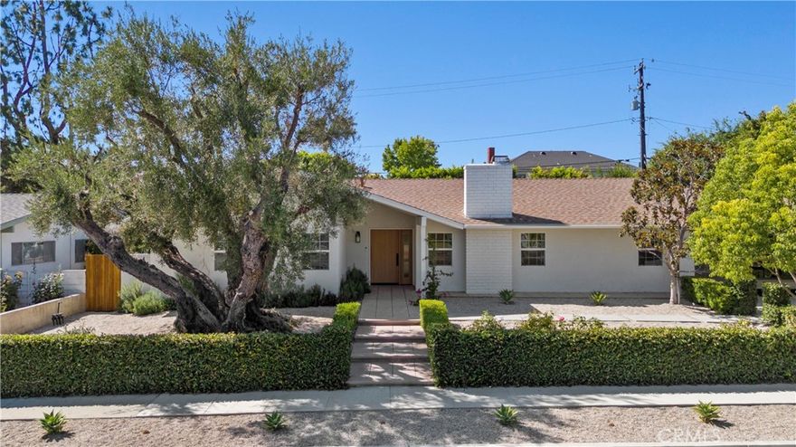 This stunning single-story luxury residence offers the rare opportunity to own a completely re-imagined home in the heart of Thousand Oaks. With 4 bedrooms, 3 full bathrooms, and just under 2,100 sq. ft. of thoughtfully designed living space, every inch has been transformed with meticulous attention to detail and high-end finishes, making it feel like new construction. Step through the custom white oak front door and into an open, airy floor plan bathed in natural light. Brand-new luxury flooring flows seamlessly throughout, complementing the organic modern design. The showpiece kitchen is a chef’s dream, boasting Taj Mahal quartzite countertops with a waterfall island, custom cabinetry with Restoration Hardware accents, and top-of-the-line Viking appliances. Each bathroom has been tastefully remodeled with spa-like finishes, while the limestone wash fireplace and flush recessed vents add subtle sophistication to the living areas. Additional upgrades include a brand-new AC and heating system, recessed lighting with a nightlight feature, Nest smart home integration, and freshly painted interiors and exteriors. The lifestyle continues outdoors with a newly built cedar wood pergola perfect for entertaining, a finished garage with a full-view luxury glass door, built-in laundry station and cabinets, and a pool-sized backyard framed by mature fruit trees. This isn’t just a renovation, it’s a reinvention. A home where every detail feels purposeful, elevated, and timeless.