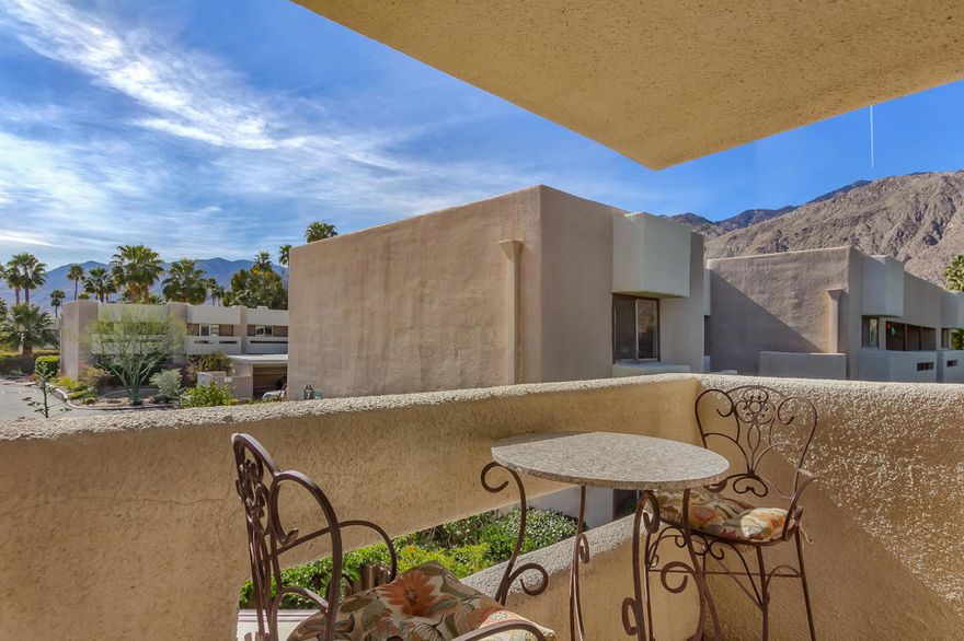 Highly upgraded/renovated end unit townhouse w/ South facing patio in gated Hermosa Villas.  Located in the rear of the complex away from traffic noise, this condo was extensively renovated about 10 years ago and includes new double pained windows and sliders throughout, as well as all new kitchen and baths.  There is high end flooring, accent wood flooring on the stairs and upper landing and use of pocket doors throughout the home to ensure the efficient use of space.  Kitchen features Cherry cabinets, Corian counters and stylish black appliances including double drawer Fisher Paykel dishwasher.  The main floor bath has been expanded to include a spa like shower.  The upstairs bath has also been beautifully renovated.  This is an end unit.  It features a very private rear patio, amazing mountain views and has a rare laundry closet, which is grandfathered.  On-demand hot water and a covered assigned parking space just behind the unit complete the picture.  Within walking or biking distance to shopping and downtown Palm Springs.  Don't wait; make your appointment to see this perfect Palm Springs Pied a Terre today!