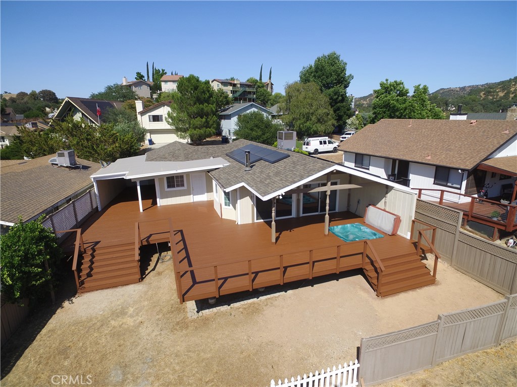 Classic Lake House in Heritage Ranch, just in time for summer! The home enters through a large breezeway with full wrap around decking. Once inside you'll find an open layout with excellent views from the kitchen and living area. Two large sliders connect to a huge private sun deck with built in Jacuzzi under a large awning. The backyard deck and spa are very private, and overlook a deep canyon and hillside landscape, which brings a great feel of space and openness into the home. In addition to the views, the kitchen features granite tile counter tops with textured edge, under cabinet lighting, built-in pantry and wine storage, and all new appliances. The home itself has fresh paint inside and out, wood flooring throughout, a brand new roof, a new central air conditioning and heating unit, and a wood burning stove in the living room. There is also a 8.20kW Tesla Solar System with Powerwall 3 battery storage. The master bathroom features custom tile shower and countertops, and a jacuzzi tub with dual shower heads. There is also a super deep garage which can accommodate a large ski or wakeboard boat. This home is well cared for and ready for a new owner!