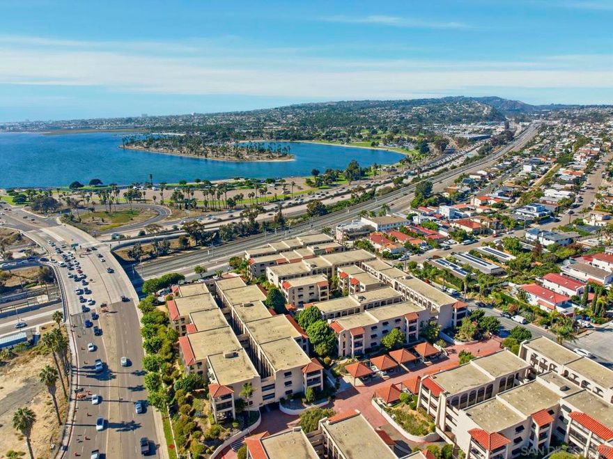Embrace a life of leisure and beauty in this stunning Bay Park condo, where every day feels like a vacation, within walking distance of Mission Bay. This desirable 2-bedroom, 2-bathroom single-level gem offers delightful views from a spacious balcony, showcasing the inviting pool area. Imagine sipping your morning coffee or dining al fresco while soaking in the serene poolside ambiance.  Inside, neutral tones and spacious bedrooms accompany open-concept living and dining areas, ready for your coastal design. The modern kitchen is equipped for culinary adventures with a range and refrigerator. For comfort and convenience, you'll find an in-unit laundry.  This is more than a condo; it's a lifestyle within a gated community featuring a pool and spa and mature landscaping. Enjoy the added convenience of two parking spaces and easy elevator access.  The prime location is unbeatable. With easy freeway access, you’re just minutes from Mission Bay, beautiful beaches, dining, and shopping. The nearby Clairemont Blvd Blue Line Trolley provides effortless access to UCSD, UTC, Downtown, and more! Endless fun awaits, whether you're heading out for a surf, paddle, or bike ride.  Come relax and fully embrace Bay Park and Mission Bay lifestyle, where every sunset is a celebration. Don’t miss your chance to make this coastal paradise your own—schedule a viewing today!