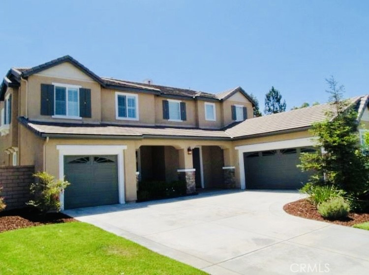This exceptional residence is nestled in a premier cul-de-sac location, offering architectural elegance and abundant natural light. The formal living room boasts soaring ceilings, complemented by rich dark hardwood floors and elegant 18-inch ceramic tile. Granite accents and crown molding enhance the sophisticated ambiance, while plantation shutters add timeless style throughout.A butler’s pantry connects the formal dining area to the stunning eat-in kitchen, which opens seamlessly to a gracious family room with a cozy fireplace. The main level includes a bedroom and full bath, while dual staircases lead to an inviting media loft upstairs. The luxurious primary suite features a spacious walk-in closet and a master bath with a jetted tub. Additional storage can be found beneath the stairs.The exterior is framed by professionally designed, park-like grounds on a king-sized lot that is pool-ready. An oversized stamped concrete patio—plumbed for a gas barbecue—plus a glass fire pit create an ideal setting for outdoor living.Enjoy mountain views and the benefits of the highly regarded Etiwanda School District, with nearby Legacy Park, Olive Grove Park, bridal paths, and Victoria Gardens.