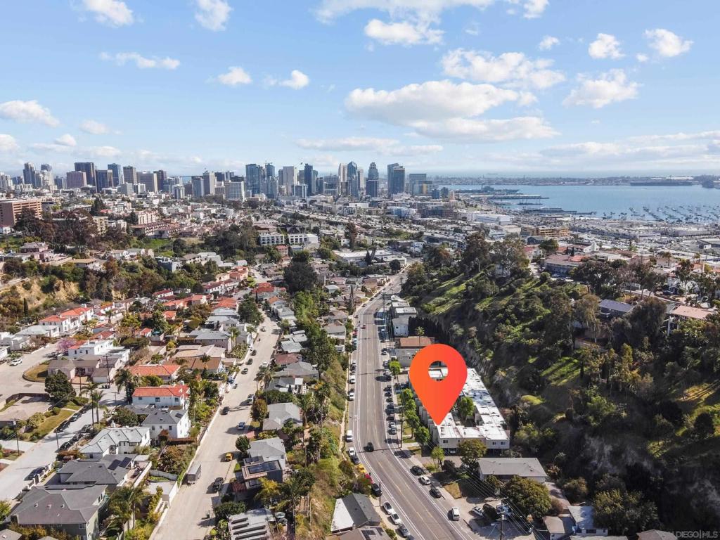 With an open-concept layout, a private enclosed front patio, ground-level entry, THREE closets, TWO assigned parking spaces and an approved government program in place to upgrade the windows and sliders, this Mission Hills condo offers rare convenience and comfort in one of San Diego’s most charming neighborhoods. Tucked into a quiet pocket of Mission Hills, it blends privacy, character, and everyday ease. You can walk to Little Italy, Hillcrest, and Mission Hills, making it easy to enjoy some of the city’s best dining, shopping, and culture. Inside, the smart floor plan includes a built-in Murphy bed and desk, creating a flexible, functional living space. Step out to your own enclosed patio, perfect for slow mornings or quiet evenings.
