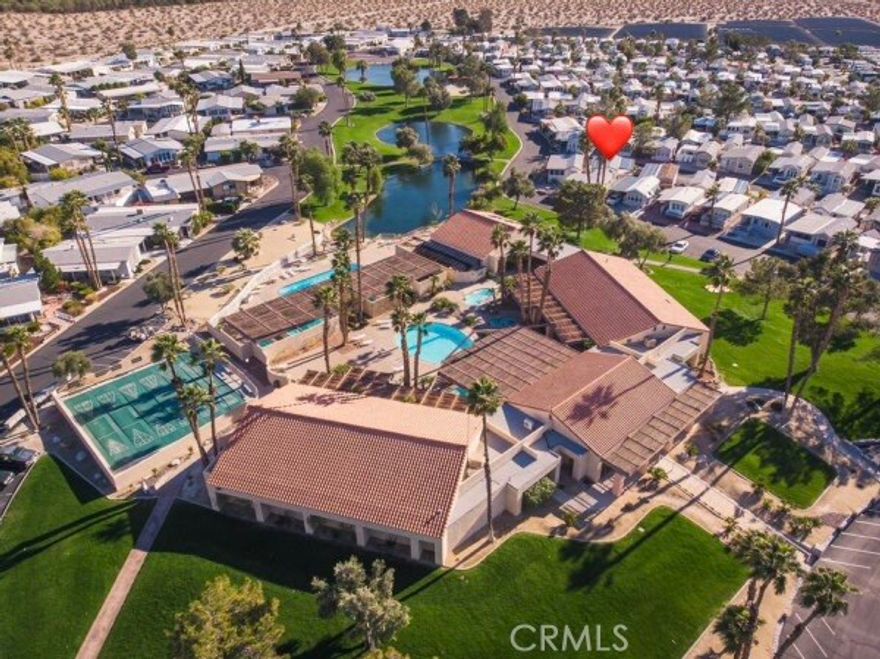 Great location in the park—without premium space rent!
This well-maintained home is just steps from the lake and the East Clubhouse. Inside, you’ll find a bright and welcoming living room, a primary bedroom, and an additional bedroom or the California room. The home features laminate flooring throughout, offering a clean and modern feel.

The kitchen includes generous cabinetry and a dishwasher, with an open layout that flows seamlessly into the living room and hallway, bathroom and bedroom. Outside, the long paved side yard provides additional parking and leads to a spacious, upgraded porch with an awning—ideal for outdoor dining, relaxing, and entertaining.

The cozy backyard is also paved and features installed cloth lines, allowing you to dry clothes and towels naturally in the warm California sunshine. A convenient storage shed provides space for tools and supplies, and the washer located inside the shed offers a "luxury" that most park model homes do not have. The home also includes a central HVAC system that keeps you cool in the summer and warm in the winter.

This gated resort community features two clubhouses and a total of 13 natural mineral hot spring pools and jacuzzis, open daily from 8 AM to 11 PM. These therapeutic waters offer relaxation, rejuvenation, and recovery. Additional amenities include:

Fully equipped gym

Pickleball courts

Tennis courts

Basketball courts

Exercise and yoga rooms

Bocce ball

Horseshoes

Outdoor fire pit

Indoor and outdoor concert stages

Wild West Wash walking trail

Two dog parks—one for large dogs, one for small

A beautiful on-site chapel offering weekly Sunday worship services

The resort and its residents host a rich variety of activities, including water ball, water aerobics, yoga classes, karaoke, dance nights, bingo, and more.

No property tax. No HOA fees.
Where else in California can you own a home for under $1,000 per month total, even with a loan?

Conveniently located within 15–20 minutes of Desert Hot Springs, Palm Springs, Palm Desert, Rancho Mirage, and Indian Wells, this home offers easy access to everything the Coachella Valley has to offer.

Come and live your dream California lifestyle!