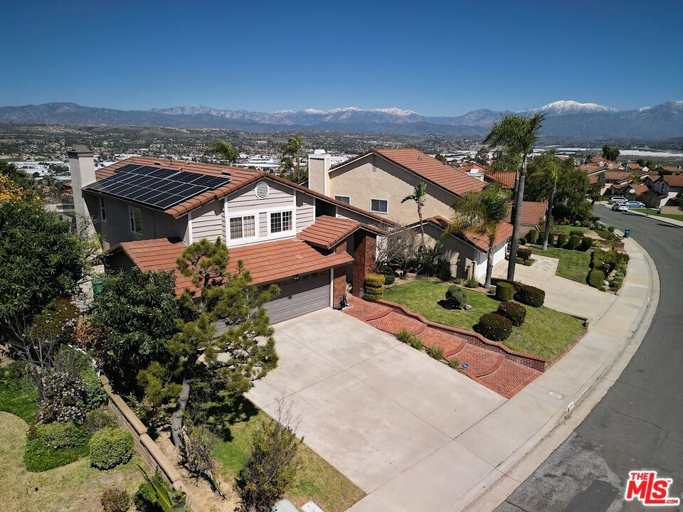 Modern Comfort with a Stunning City View! This beautifully upgraded 4-bedroom, 3-bathroom home offers 2,803 square feet of stylish living space on a spacious 10,176 SF lot perfectly blending comfort, functionality, and stunning city views. Step inside to discover light-filled interiors and a smart, functional layout.High vaulted ceilings create an open, airy feel throughout. The living and dining areas flow seamlessly-ideal for hosting friends and family. The main level includes a bedroom and full bathroom, perfect for guests or in-law stays. Upstairs, you'll find two generous bedrooms and a full bathroom, along with a luxurious primary suite featuring panoramic views, a private balcony, and a spa-inspired en-suite bathroom. The recent updates add tremendous value and convenience, including: *Upgraded circuit breaker, *EV charger-ready and solar equipped -14 Hanwha Q CELLS solar panels (installed 2023, 25-year warranty)* Roof and balcony repairs completed* Motion-sensor lighting in the backyard* New garage motor + installed Tesla charger* Brand new washer & dryer, *Updated outdoor lamp posts with new bulbs and modern cases* Bonus: Electric grill included with the sale! Enjoy seamless indoor-outdoor living with a large backyard-ideal for entertaining or simply unwinding under the stars. The unbeatable location puts you near top-rated schools, parks, shopping, and freeway access. This a must-see--Rare opportunity to own a move-in-ready home with unbeatable views in a prime location! APN:8765-006-007