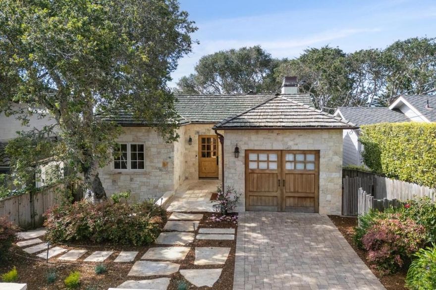 Nestled in the coveted Golden Rectangle of Carmel-by-the-Sea, this stunning home offers the perfect blend of luxury and coastal living. Just down the street from La Playa and 3 quick blocks to the white sands of Carmel Beach and the vibrant downtown, this spacious home features ocean views and impeccable craftsmanship throughout. The elegant layout encompasses 3 bedrooms, 3.5 baths, and over 2,500 square feet of living space. The home features high open-beam ceilings, French Oak wide-plank floors, and 3 Carmel stone fireplaces. The main level primary suite opens to a sunny patio with peeks of the ocean. The chef's kitchen, dining, and family room seamlessly flow onto a west-facing deck, perfect for enjoying the glowing sunsets. Downstairs, a separate entertainment den with a fireplace and wet bar awaits, along with two generous bedrooms, including a second primary suite with access to the patio. From hand-carved corbels to hand-wrought iron railings, every detail is thought out. This home is an exceptional opportunity to live in and experience the quintessential Carmel-by-the-Sea lifestyle where you get the beach and town when you want.and then simply retreat and relax back to your own Carmel home.