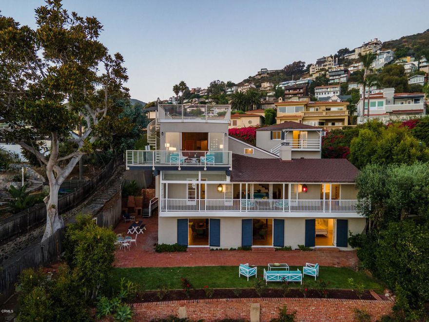 First time on the market in 60 years! If you're looking for character and direct oceanfront with spectacular views, look no further than this Laguna Beach gem! This extremely rare 1935 Cape Cod - inspired home features 5 bedrooms and 6 baths on a spacious 7,345 sq. ft. lot with direct access to West Street Beach. Three levels span 3,106 square feet of gorgeous living space which includes a guest apartment above the garage and magnificent rooftop deck where captivating views take your breath away. Inside, find exquisite attention to detail including original hardwood flooring, lovely French doors, built in shelving and incredible wood work. Unwind to the sound of the waves in the formal living or family room where sliding doors and large windows frame the scenic seascape. Perfect for entertaining, ocean facing decks on every level total approximately 1100 sq. ft. of outdoor living space overlooking the lush lawn, colorful roses and tantalizing ocean beyond. This ideal location includes onsite parking, garage and is walking distance to Aliso Beach and Montage Resort. An unparalleled original masterpiece, so many unique features and original detailing make this home beautifully one of a kind. Truly a must see - come visit one of Laguna's finest waterfront homes. Video available hit photo link.