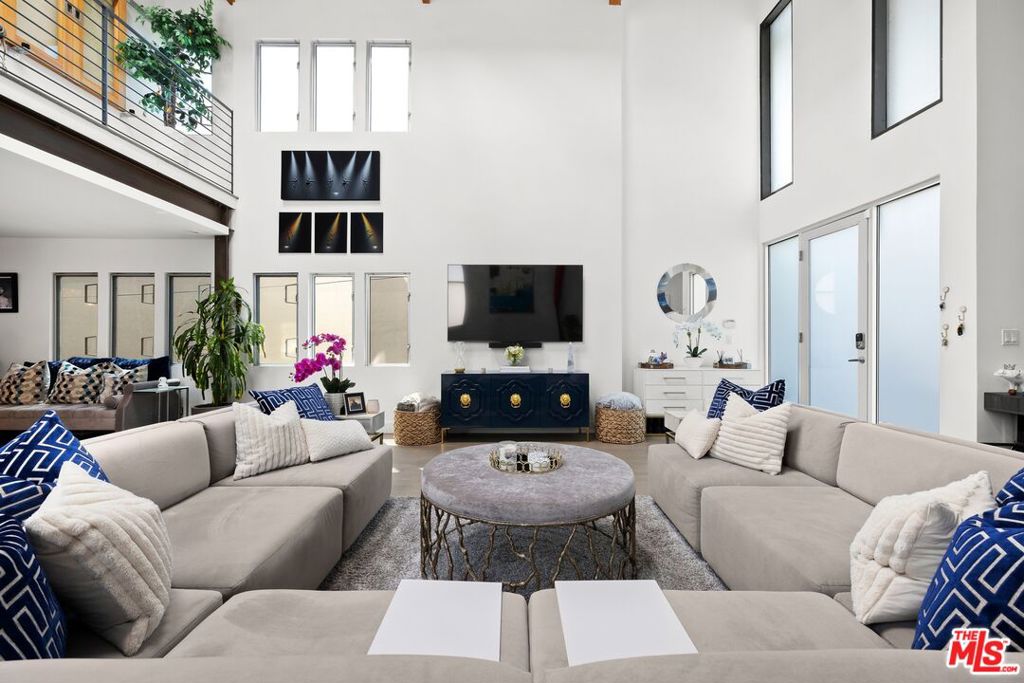 This beautifully upgraded 4-bedroom, 3-bathroom home offers 3,586 sq ft of luxury living, including 800 sq ft of newly added bonus space downstairs. Ideally located just steps from the beach in the heart of Venice, it's perfect as a primary residence, vacation getaway, or turnkey rental. Fully furnished and rental-ready, it's poised to generate income from day one. The open floor plan connects spacious living, dining, and kitchen areas, featuring high-end appliances and a large island ideal for entertaining. Two newly added downstairs bedrooms provide flexible bonus space for guests, a home office, or gym. Upstairs, the primary suite includes custom closets and is paired with an additional guest bedroom. An oversized 3-car garage offers ample room for parking, storage, a sauna, and even a workshop. With a prime coastal location and strong rental potential, this exceptional property blends comfort, convenience, and investment opportunity in one compelling package.