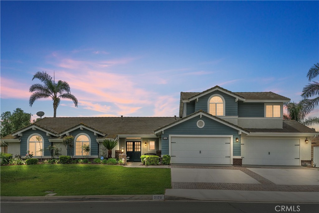 Welcome to this stunning pool home located in the highly sought after neighborhood of Sycamore Ranch. Designed for entertaining and comfortable living, this home has a terrific open floor-plan featuring 5 bedrooms, 3.5 baths, and lives like a single story with the primary suite downstairs.
Upon entry, you are greeted by the living room and dining room with high ceilings, a wall of windows and sliding doors opening to the backyard for indoor outdoor living. The gorgeous kitchen features wood cabinetry, granite countertops, KitchenAid stainless steel appliances, stainless steel sink, a large center island, and plenty of storage and counter space. The kitchen opens to the breakfast nook and family room with gas fireplace and high ceilings. Features include wood flooring, new carpet, fresh interior paint, updated lighting, recessed lighting, dual zoned A/C, Flow-Tech filtration, and dual pane windows. Downstairs includes a powder room, laundry room with sink and granite counters, three secondary bedrooms and a remodeled secondary bath with dual sinks and granite counters. The beautiful primary suite features a wall of viewing windows and sliding door leading to the pool and spa, includes two walk in closets, a remodeled bath with granite counters, dual vanity sinks, shower, soaking tub and privacy door. Enjoy the upstairs flex space with bonus room, bedroom and remodeled full bath which is a great space for guests or family. The backyard paradise is lushly landscaped with an expansive lawn, palm trees and a large covered patio spanning the width of the home. Enjoy the sparkling pool and spa with hardscape offering multiple seating areas for relaxation and entertaining, custom built-in barbecue center with a Bull grill, 2 burners, sink, refrigerator, storage, and plenty of seating. There is a putting green and pitching pad with new turf. Situated on one of the 10 largest lots in the neighborhood, this expansive property provides opportunity and privacy. The corner lot offers a side gate to the back property. There is plenty of room for the potential addition of RV parking and room for horses and animals. Includes 40 Paid For Solar Panels, 4-car garage with epoxy flooring, and storage cabinets, and beautiful curb appeal. This is a terrific neighborhood with horse trails, Pacer park, riding arena down the street, nearby shopping, restaurants, schools and freeways. Low taxes and No mello roos. This a wonderful opportunity.