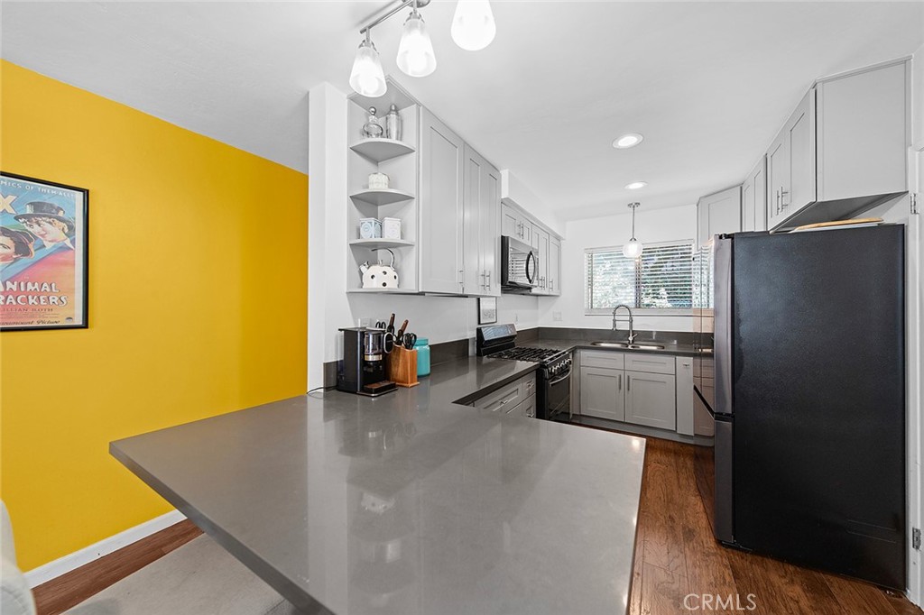 Fully Remodeled Townhome-Style Own Your Own (OYO) Unit in Prime Long Beach! This beautifully updated 2-bedroom, 1.25-bath townhome offers incredible space and value in one of Long Beach’s fastest-growing neighborhoods—just blocks from the beach! Enjoy a modern interior with quartz countertops, stainless steel appliances, dark wood floors, and fresh paint throughout. The spacious layout includes a bright living room with sliding doors to a private patio, in-unit washer/dryer hookups in a closet off the kitchen near the half bath, and two large bedrooms upstairs with a full bath. Tucked on the garden side of the complex and close to the 4th Street Corridor, this is a rare chance to own in an up-and-coming area at an unbeatable price. Don’t miss out and see you in escrow!