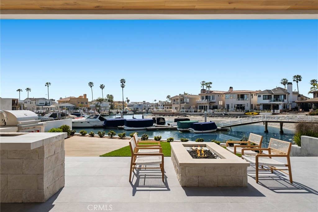 Welcome to one of Newport Beach's iconic trophy properties on the waterfront! An incredible opportunity awaits beach and bay enthusiasts in this brand-new construction home, just a 5-minute bike ride to Lido Marina and the beach, and close to the world-famous Wedge.This cutting-edge smart home, designed by renowned architect Craig Hampton and built by RDM Contractors, is meticulously crafted with European white oak floors, top-of-the-line Wolf and Sub-Zero appliances, and luxurious natural stone and tile finishes accented by oak & T&G ceilings. The talented team at MID Interior Design has created an inviting interior that truly feels like home.For wine lovers, the property includes a temperature-controlled wine cellar with room for nearly 100 bottles—ideal for entertaining or curating a private collection.Perfectly positioned on the water and within a 10-minute walk to both the beach and Lido Marina, this home offers smart technology features customizable to your lifestyle. Located in the gated community of Balboa Coves, residents enjoy easy freeway access and close proximity to Lido Isle and Fashion Island, as well as community perks like a dog park and kids' playground.The residence offers approximately 3,753 square feet of living space—over 5,000 square feet including garage and decks—on an EXTRA WIDE 3,888-square-foot lot. Inside, you’ll find 4 bedrooms and 4.5 bathrooms, giving everyone their own private retreat. With three-car parking, space is never an issue.A private rooftop deck with a bonus bed and bath is perfect for entertaining or taking in the panoramic views. You’ll also have direct access to the calm bay waters, with a private dock suitable for a boat up to about 35 feet—ideal for boating enthusiasts or anyone who values a waterfront lifestyle.Don’t miss this rare opportunity. Live the beach and bay life you’ve always dreamed of by making this exceptional new home yours. Start creating unforgettable memories in this idyllic setting today.
