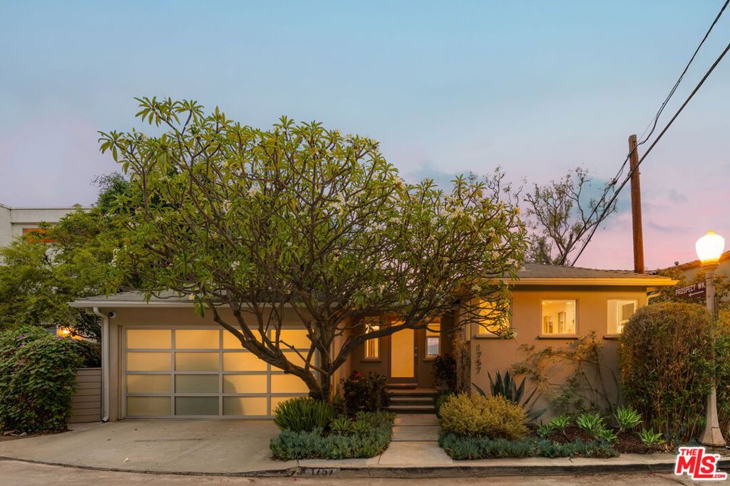 Perched in the tranquil hills above Los Feliz, 1757 Hollyvista Avenue is a charming sanctuary that perfectly balances the serenity of hillside living with the vibrancy of its surrounding neighborhood. Located in the sought-after enclave of Franklin Hills area of Los Feliz, this thoughtfully designed residence offers sweeping panoramic views that stretch from Griffith Observatory across the city skyline, filling the home with natural light and a profound sense of space. The grounds are equally captivating, with mature trees and beautifully landscaped gardens that create a lush sense of privacy. Plumeria fills the air with fragrance, a crape myrtle adds vibrant color, and a stately magnolia lends timeless grace. These plantings frame the terraces and patios, making every outdoor moment- morning coffee, an al fresco dinner, or an evening beneath the stars. Inside, the home seamlessly blends original architectural details with tasteful modern updates , 3 large en suite bedrooms, & one half bath, hardwood floors, custom finishes, and an effortless indoor-outdoor flow that embodies Southern California living. Expansive windows and private terraces invite the outdoors in, blurring the line between home and garden while offering spaces of calm and inspiration. Beyond its walls, the neighborhood of Franklin Hills is rich in character and culture. Known for its winding streets, mature trees, and a mosaic of architectural styles ranging from Spanish Revival to Mid-Century Modern, the area exudes historic charm and creative spirit. Residents enjoy close proximity to the best of Los Feliz Village and Silver Lake, including beloved local cafes, boutiques, markets, and cultural hotspots. Whether strolling through nearby parks, hiking the Griffith Park trails, or enjoying live performances at the Greek Theatre, 1757 Hollyvista places you at the heart of LA's most desirable lifestyle.