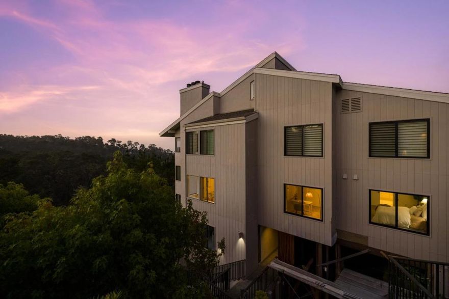 If you love massive views and don't want to deal with a single stair, you need to see this exceptionally appointed condominium. A corner unit on the ground level of the gated Shepherd's Knoll complex, with Pebble Beach's Highway 1 Gate just around the corner, it offers unmatched access to the entire Monterey Peninsula. Rising up dramatically from the edge of a forested hillside, Shepherd's Knoll astonishes residents with the jaw-dropping heights it's able to offer those on every floor. This particular unit has the added benefit of sitting at the far end of its building, meaning its next owner will enjoy enhanced privacy and even better views of the Pacific Ocean and Del Monte Forest. Set the mood in the living room with your favorite music and a fire in the fireplace. Kick back with a glass of wine as light pours in through wall-to-wall windows that invite you to gaze over lush treetops at the placid expanse of ocean blue beyond. Strategically placed mirrors cast these brilliant impressions everywhere you turn and make an already spacious room feel even bigger. Step onto the balcony to immerse yourself even deeper in the incomparable beauty of Pebble Beach. This unit has a formal dining room, a lovely kitchen, a huge primary suite, two extra bedrooms, and more. Welcome to bliss.