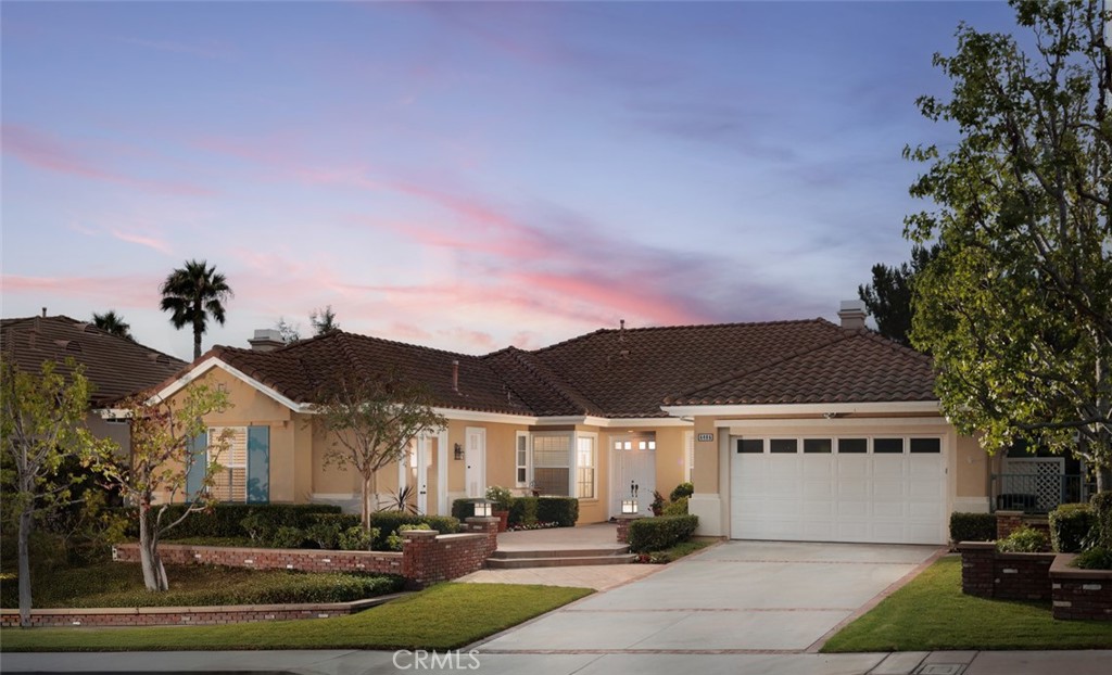 GATED PARKRIDGE ESTATES COMMUNITY | MOVE-IN READY | LIGHT & BRIGHT LIVING SPACES | Welcome to 6406 E Abbeywood Road, a beautifully updated home nestled within the gated Parkridge Estates community in the hills of Orange. With fresh finishes, thoughtfully designed interiors, and access to top-notch amenities, this property combines convenience, comfort, and style in one of the area's most sought-after enclaves. From the moment you step inside, you’re greeted by a spacious open layout flooded with natural light. Crisp white walls, warm-toned wood flooring, and elegant crown molding create a modern yet welcoming ambiance throughout. The living and dining areas flow seamlessly into the heart of the home, a large open-concept kitchen and family room anchored by a cozy fireplace. Whether you're entertaining or enjoying quiet evenings in, this flexible space adapts to any lifestyle. The kitchen features solid wood cabinetry, granite countertops, and a central island that serves as the perfect prep space or breakfast bar. Ample cabinet storage and high-end appliances make this a kitchen that’s as functional as it is beautiful. Large dual-pane windows and plantation shutters frame views of the private backyard and covered patio, which is an ideal spot for al fresco dining or winding down after a long day. The generously sized primary suite offers direct access to the backyard, along with a walk-in closet and an updated en-suite bath featuring dual sinks, a soaking tub, and a walk-in shower. Three additional bedrooms, one with an en-suite bathroom and two with a shared hall bathroom provide flexible space for family or guests. An oversized office space adds even more versatility as it is ideal for a home workspace, media room, playroom, or second entertaining area. Outside, the low-maintenance yard includes mature landscaping, manicured hedges, and multiple seating areas perfect for enjoying Southern California’s indoor-outdoor lifestyle. The Parkridge community enhances the experience with two private gates, a sparkling pool and spa, a sport court, and BBQ areas, all of which are ideal for gatherings and weekend relaxation. Enjoy close proximity to local hiking and biking trails, shops, dining, award-winning schools, and the best of what Orange has to offer. Come see why homes in Parkridge are rarely available.