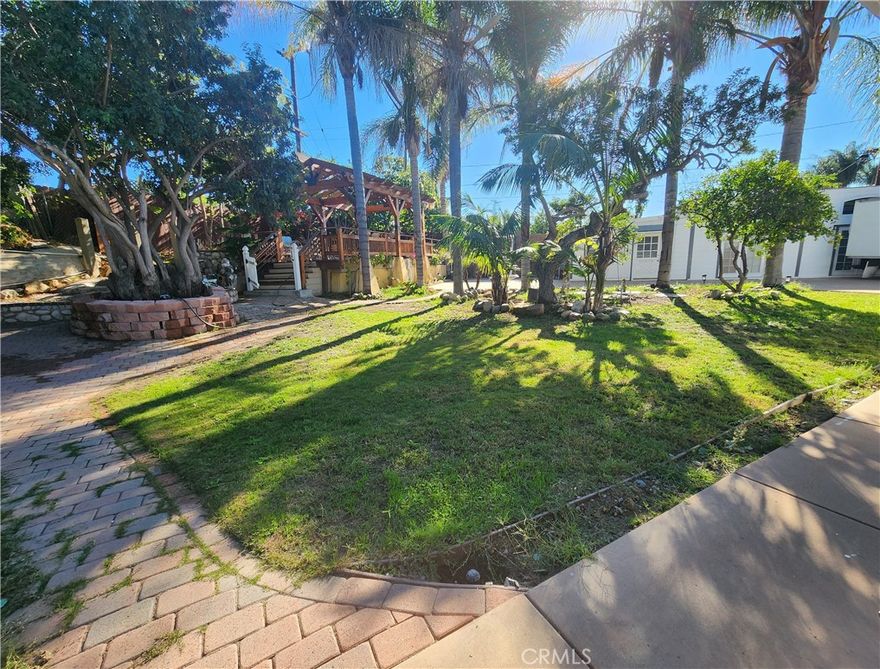 An exceptionally rare find and secluded sanctuary property, where a large single-story ranch house sits on a massive 16,113 sqft flat lot at the end of a cul-de-sac in a quiet family neighborhood. This residence offers approximately 2,500 sqft of living space and features 5 bedrooms and 2.5 baths, plus additional living areas which may present future utility. Has been used as a Daycare for a long time. The property offers tremendous flexibility and is perfect for a multi-generational estate, a unique business use, or a substantial investment opportunity. The expansive lot is a true paradise for large events, featuring a resort-caliber redwood gazebo, outdoor cooking area, wide array of mature fruit trees, and an enormous paved area with room for 12+ cars or multiple RVs/boats. Leverage this property and its huge lot to create your own masterpiece, build, expand, add a pool and or alternate income producing opportunities. The property will be delivered vacant at COE. Very close to ample shopping, entertainment, and major freeways. A large Single-Story property with such giant flat and usable backyard is extremely rare in south orange county, Act Fast. By Appointment Only