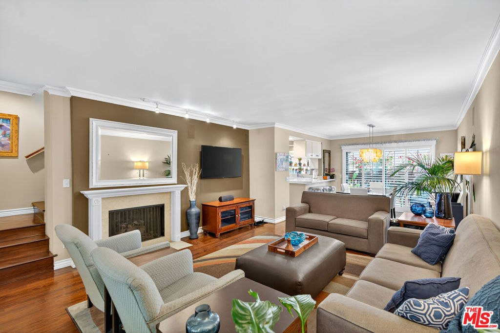 Nestled on a tree-lined street in one of Santa Monica's most coveted neighborhoods, 913 17th Street is a refined 2-bedroom, 3-bathroom townhome offering the perfect blend of luxury, comfort, and coastal sophistication just moments from the ocean. Located just blocks from the heart of Montana Avenue, this home places you steps from some of Santa Monica's most beloved destinations. Stroll to charming boutiques, award-winning cafes, artisanal coffee shops, and locally loved restaurants that give the neighborhood its vibrant, walkable character. Whether you're starting your day with a pastry from a neighborhood bakery or enjoying a sunset dinner with friends, Montana Avenue offers an upscale but uniquely relaxed lifestyle that perfectly complements this elegant townhome. This beautifully updated residence features two serene private patios ideal for alfresco dining, entertaining, or simply enjoying the fresh coastal breeze less than 2 miles from the beach. Inside, natural light pours into the spacious living room, complemented by an elegant separate dining area that seamlessly opens to the rear patio. The kitchen is appointed with sleek stainless-steel appliances, refined cabinetry, and tasteful finishes, perfect for both everyday living and upscale entertaining. Retreat upstairs to the gracious primary suite, complete with a cozy fireplace, a private balcony framed by lush treetop views, and an ensuite bathroom featuring a large walk-in shower and sophisticated design touches. The second bedroom offers its own full bath, providing comfort and privacy for guests or family. Additional highlights include a living room surround-sound system and direct access from a private two-car garage, in-unit laundry, and thoughtful storage throughout. Tucked beneath the hiking trails of the Santa Monica mountains, 17 blocks from the blue Pacific, your new home lies in a modern urban forest. From your house, you can walk or bike to almost anything you need under a canopy of palm or fig trees -streets lined with blazes of bougainvillea, scented by jasmine and rosemary. Here, you'll find a neighborhood that's quiet and safe with a great mix of friendly neighbors walking their dogs or pushing strollers. Whether you're a young couple seeking work in Silicon Beach, retirees looking for a permanent, year-around vacation home, or a young family wanting your kids to walk to top-notch schools, you'll find the warm winter sun and cool summer breezes caressing your home and nourishing your spirits.