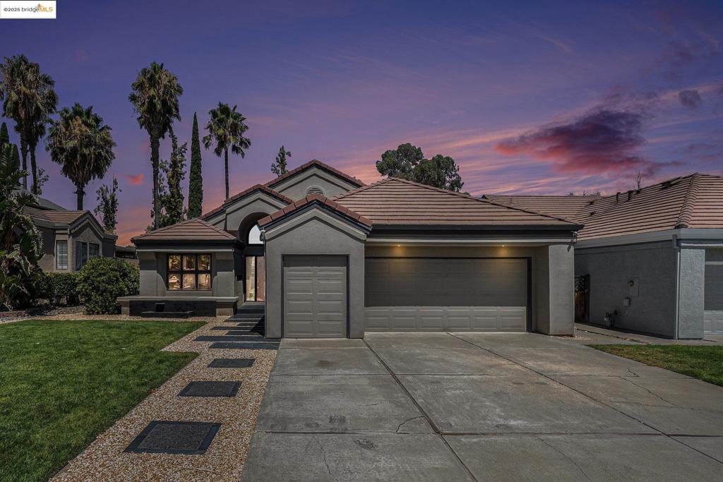 Experience elevated living in this modern, sexy single-story home, set on the 11th tee of the prestigious Discovery Bay Country Club. Designed with sophistication and comfort in mind, this 3-bedroom, 2-bath home offers 1,868 sq ft of light-filled space with panoramic views of the fairway and pond. The expansive living and dining areas feature a cozy fireplace and a custom wet bar with a floor-to-ceiling wine refrigerator—perfect for entertaining. The chef’s kitchen boasts high-end commercial appliances, quartz countertops, Heath Ceramic oval tile backsplash, and awning windows that bring in natural light and fresh air. The spa-inspired primary suite is a showstopper, with a custom two-person shower, dual showerheads, striking tilework, and luxe finishes that transform daily routines into a luxurious escape. Both bathrooms are fully upgraded with tile flooring, tiled showers, new countertops, modern sinks, and premium Kohler fixtures. Additional finishes to the home include home sound system, wood, tile, and carpet flooring, a new HVAC system, and fully owned solar. The backyard retreat features a large built-in gas firepit and spa, and the oversized 2-car garage includes additional golf cart parking space. Welcome to resort-style amenities and golf course living!