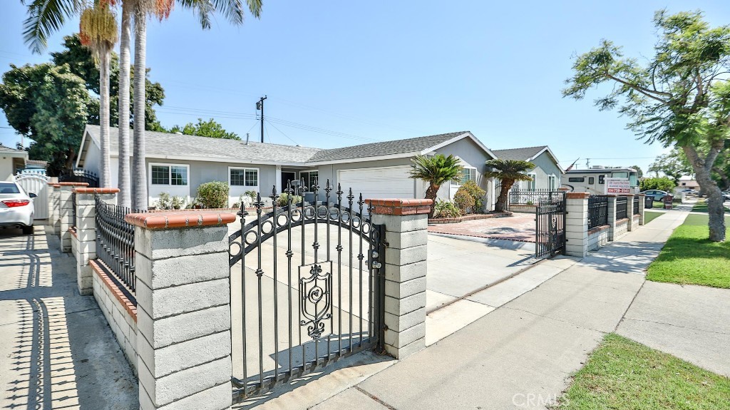 This is a NICE Location in Santa Ana! Nestled in the vibrant heart of Santa Ana, California. This 3 Beds (additional 2 bedroom added. Total 5 bedrooms) & 2.5 Baths home is next to the New Crystal Track Homes and closed to Fountain Valley, Westminster, Garden Grove. This home has Large Concrete Driveway, Brick planter in the front, 2 Car Garage access to Kitchen, and plenty of parking space on driveway. Fireplace is in the Living room, Laundry room has 1/2 bath. Master bathroom has vinyl tile. Back yard has an open patio, and with 8 x 12 toolshed & a lot of fruit trees..Block walls around back and front yard, and iron gated front. Walking distance to La Quinta High School & Mile Square Park. Easy to access to 405 & 22 fwys.