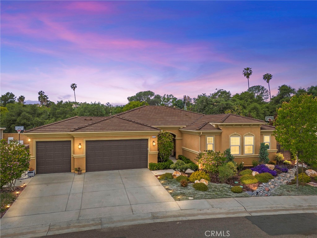 Welcome to 2569 Pasture Glen, nestled in the exclusive gated community of Oak Creek—an intimate enclave of just 64 homes where opportunities to buy are rare. This beautifully designed single-story residence offers 2,389 square feet of stylish living space with 3 bedrooms, 2.5 bathrooms, and a flexible room currently used as an office/workout space that could easily be converted into a 4th bedroom. Thoughtful design meets comfortable living with hard surface, wood-look flooring throughout and seamless indoor-outdoor flow via a 3-panel sliding glass door that opens to a covered patio—perfect for soaking in Escondido’s year-round sunshine. Set on a private 10,019 square foot lot with no rear neighbors, there’s ample room to design your dream backyard or future pool oasis. The chef’s kitchen features a large quartz island with seating, stainless steel appliances, and abundant counter space. The spacious primary suite is a true retreat with a spa-like bath boasting custom tile flooring, a soaking tub, glass-enclosed shower, dual sinks with a separate vanity, and a massive walk-in closet. Additional features include owned solar, a 3-car garage, and modern finishes throughout. Directly across from the expansive 346-acre Felicita Park, residents enjoy access to scenic trails, picnic areas, and natural creekside beauty. With quick access to the 15 freeway and nearby shopping, this home blends privacy, luxury, and convenience in one unbeatable location.