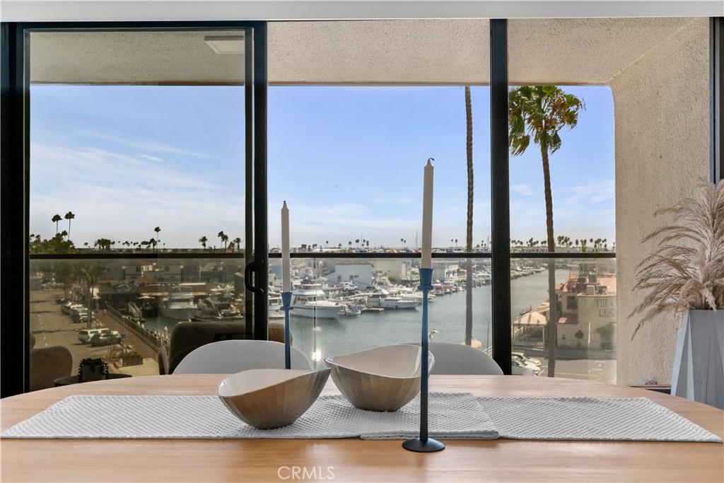 Experience luxury bayfront living at 601 Lido Park Dr #3F, a beautifully renovated high-rise condo with sweeping views of the harbor, ocean, Catalina, and city lights. This 1,850+ sq. ft. residence offers two spacious bedrooms, two full bathrooms, and a powder room. The open kitchen features widened walls, semi-custom light oak stained cabinetry, quartz countertops, a stainless steel sink, brand new top-of-the-line KitchenAid appliances, and a built-in bar facing the family room with wine storage. The expansive balcony off the living room and kitchen is the perfect spot to enjoy harbor and ocean scenery. Both bathrooms include new vanities, quartz counters, mirrors, and lighting. The master bath boasts a double-sink vanity and marble-accented shower with hexagon tile flooring. Additional updates include newly refinished wood floors, freshly painted walls, modern lighting, and the removal of dated mirrors for a clean, contemporary look. Enjoy the convenience of in-unit laundry and secure underground parking. Residents have access to resort-style amenities, including 24/7 doorman and security, a fully equipped fitness center, clubhouse/entertainment room, swimming pool and spa, and a stylishly updated lobby. Private boat dock access is available (subject to availability). All just steps from Lido Marina Village, Nobu, and The Cannery.