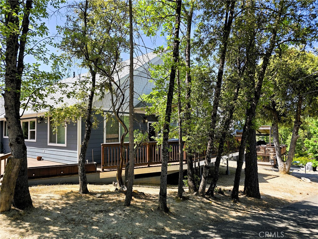 Welcome Home to Modern Mountain Living with STR Potential!
Built in 2016 and tucked just steps from Bass Lake’s shoreline, this custom single-story home is one of the newest in the area—offering fresh design, prime location, and short-term rental eligibility in a high-demand market.
Set on a corner lot near The Pines Resort and village market, the home features nearly 2,000 sq ft of open concept living with soaring ceilings, wide hallways, and natural light throughout. The kitchen is a true standout—complete with granite counters, a walk-in pantry, and a built-in wine bar with fridge—perfect for hosting or winding down after a day on the lake.
The layout includes 3 spacious bedrooms and 2 spa-inspired baths. The primary suite offers a dual-head walk-in shower, soaking tub, and private water closet. Engineered wood floors add warmth and style throughout.
Catch the sparkle of the lake from your front deck, then retreat to the back wood deck for sunset dinners, stargazing, and laid-back conversation. With a whole-house generator, tankless water heater, oversized garage, and a convenient boat slip access via nearby Brier Dock—this home is ready for comfort, adventure and income.
Whether you're seeking a personal retreat, a high-performing STR, or both—this is where lifestyle and investment meet.