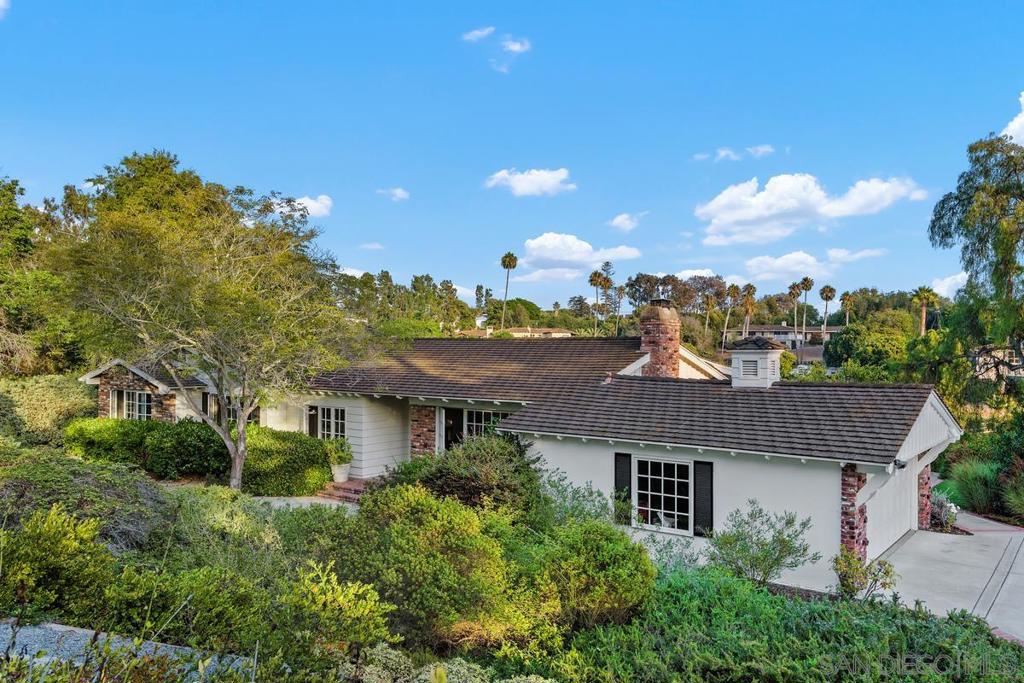 Nestled in the heart of the prestigious Rancho Santa Fe Covenant, this single-level ranch home offers a rare blend of privacy, convenience, and timeless charm. Positioned on 1.1 acres in a premier location, it’s just 0.8 miles from the award-winning Roger Rowe School (K–8) and only half a mile to one of the nation’s most exclusive golf clubs. Blending classic architectural warmth with thoughtful modern updates, the home features soaring ceilings and two fireplaces that create an airy yet intimate ambiance. Three newly renovated bathrooms — including a spa-inspired primary retreat with exceptional water pressure, bring everyday indulgence to new heights. Designed for effortless indoor-outdoor living, the residence boasts two expansive decks: one off the main living area and another at pool level, perfect for hosting gatherings of any size. A detached en-suite pool house and a separate office provide flexible space for guests, work, or creative pursuits. With ample usable land for future expansion and direct access to 60 miles of exclusive Covenant trails. 24/7 security. this property offers an unparalleled combination of tranquility, recreation, and community — all just minutes from the charming Rancho Santa Fe Village. Seize the rare chance to own a timeless home in one of the California's most desirable communities.