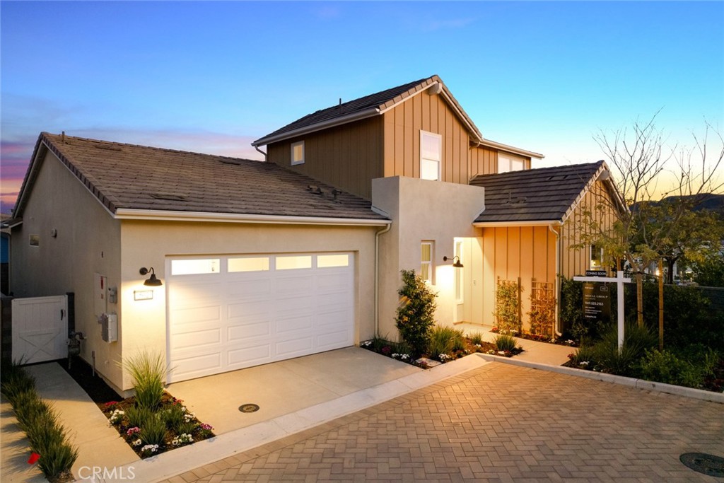 Overlooking the beautiful new Boulder Pond park from its premium elevated setting in Rancho Mission Viejo's Village of Rienda, this former model home is 100% turnkey, complete with a full complement of upscale designer furnishings and custom upgrades. A premium location in the 55-and-better Pearl at Gavilán neighborhood is enhanced by panoramic mountain and evening-light views, and a wraparound backyard with built-in fireplace, covered patio, and a custom built-in bar with smoker and refrigerator. Light, open and airy, the three-bedroom, three- and one-half-bath design extends approximately 2,257 square feet and includes a main-level den, and a large second-floor bonus room with bath that can easily become a fourth bedroom. The primary suite is located on the first level for the ultimate in convenience and hosts a generous walk-in closet, and a lux bath with clerestory window, a quartz-topped vanity with two sinks, marble tile surrounds, and a walk-in shower. Live the cherished indoor/ outdoor lifestyle for which Southern California is renowned in a seamless living and dining space that opens via two walls of slide-away glass doors to gorgeous views and the inviting backyard. Anchored by a large island with seating, the kitchen is destined to take center stage when entertaining friends and neighbors. Quartz countertops and a full tile backsplash harmonize with white Shaker cabinetry, a pantry, and stainless steel GE Monogram appliances including a built-in refrigerator and six-burner cooktop. High ceilings with flush-mount speakers, wood-style plank-tile flooring, contemporary lighting fixtures, designer wall and window treatments, interior laundry, solar power and an attached two-car garage add to the home's long list of impressive appointments. Pearl presents a resort setting where residents enjoy exclusive access to a pool and spa, clubhouse and outdoor kitchen. Located in the heart of Rancho Mission Viejo, the Village of Rienda showcases a sports club, scenic trails, a dog park, tennis and pickleball courts, and so much more. Shopping centers, preferred dining experiences, downtown San Juan Capistrano, Dana Point Harbor and miles of beaches are moments from home.
