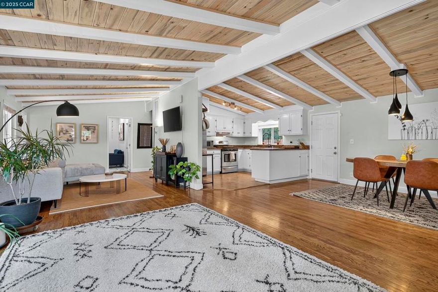 This absolutely delicious mid-century modern home blends character, charm, and a refined confidence. It’s the kind of home that makes you smile the moment you step onto the original hardwood floors under the embrace of its vaulted ceilings.  The backyard gives mini-courtyard vibes with a full-spectrum orchard of developing fruit trees: Persimmon, Lemon, Pomegranate, Apricot, Peach, and Fig, offering the kind of tree diversity that practically makes its own fruit cocktail. An additional front yard lined with mature rosemary bushes provides bonus space for any outdoor activities such as a dinner party, barbeque, play space, and more.  Conveniently located just off Highway 4, you’re less than five minutes away from grocery stores, coffee shops, and local restaurants. This home is a commuters dream. Martinez is right on the bay and has a charming historical downtown scene.