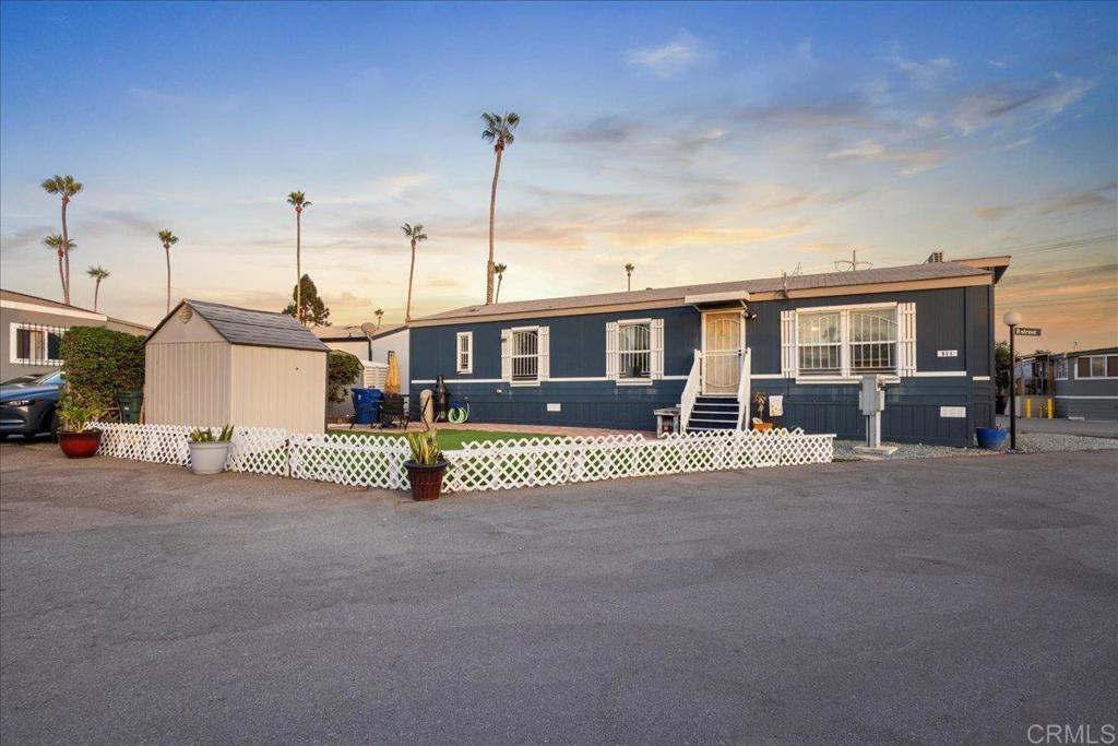 Beautiful ALL AGES 2014 3BR/2BA Manufactured Home. Rare Corner Lot with Private Patio Meticulously maintained and move-in ready, this manufactured home is located in a desirable ALL-AGE community near the 5 Freeway and Palomar. This spacious 3BR/2BA features fresh paint, new laminate flooring, updated baseboards, ceiling fans, and a full kitchen with all appliances included. Sitting on a private corner lot with no neighbors, the home offers a low-maintenance yard with upgraded turf and a private patio—perfect for relaxing or entertaining. Additional highlights include a dedicated laundry room and a covered carport. Space rent is $1,200/month with all utilities included, making it an incredible value. The community features a clubhouse, pool, and hot tub, with easy access to freeways, schools, shopping, and public transportation. A rare find with privacy, upgrades, and convenience, come see this home today before it’s gone!