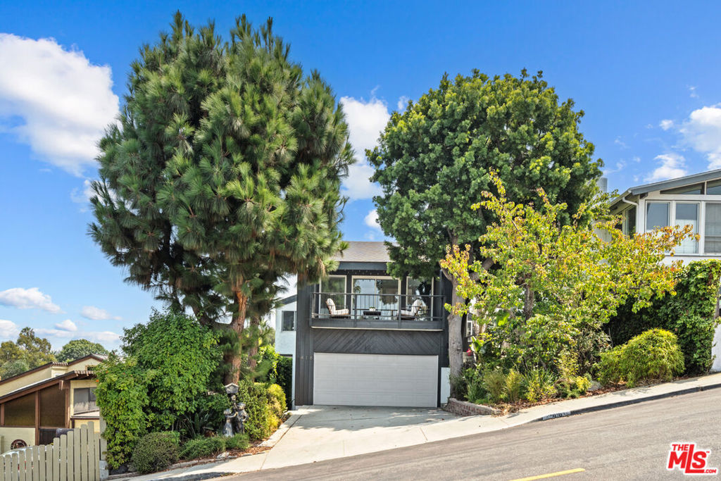 Discover this beautiful Playa del Rey retreat, where modern comfort meets laid-back coastal elegance. Just a short walk from the beach, this spacious two-story home boasts 4 bedrooms and 2.5 baths within 2,442 square feet of thoughtful living space. Step inside to enjoy glowing natural light and refreshing ocean breezes, showcased in the airy open floor plan. The kitchen, bathed in sunlight through a skylight opens to a balcony that overlooks a sparkling heated pool and Jacuzzi, perfect for lounging or entertaining. Downstairs, three bedrooms offer privacy and comfort with the master suite opening to a patio with pool and garden views. A highlight of the home is the large backyard. A winding path guides you through an enchanting Zen garden, creating a peaceful sanctuary ideal for relaxation or hosting guests. Further features include a generously sized office space with scenic mountain and city views plus a good-sized garage with storage. This mid-century charm of the home has been enhanced with tasteful updates, creating a rare find in one of Playa del Rey's best neighborhoods.