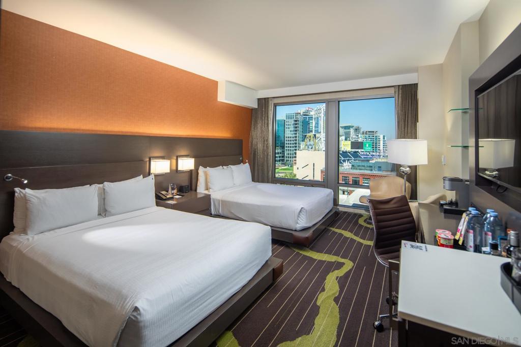 Are you ready to Rock?!! Experience the ultimate blend of luxury and lifestyle in this top-floor studio at the iconic Hard Rock Hotel in Downtown San Diego. Overlooking Petco Park and the vibrant cityscape, this sleek and spacious unit features two queen beds, a stylish sitting area, and a work desk — perfect for your city retreat. As part of a condo-hotel, owners can enjoy the space for up to 28 days per year while earning revenue through the hotel’s professionally managed rental program. Ownership comes with Rock Royalty status, unlocking exclusive perks like private concierge services, access to the Green Room Hospitality Lounge, complimentary valet parking during your stay, and invitations to VIP events. The Hard Rock Hotel boasts premier amenities including a rooftop pool with cabanas, buzzing bar and lounge, state-of-the-art fitness center, business hub, and on-site dining and shopping. Located just minutes from the airport and steps from Petco Park, the Gaslamp Quarter, the Rady Shell, and San Diego’s scenic waterfront, this is a unique opportunity to own a piece of the action — and enjoy the best of Downtown San Diego!