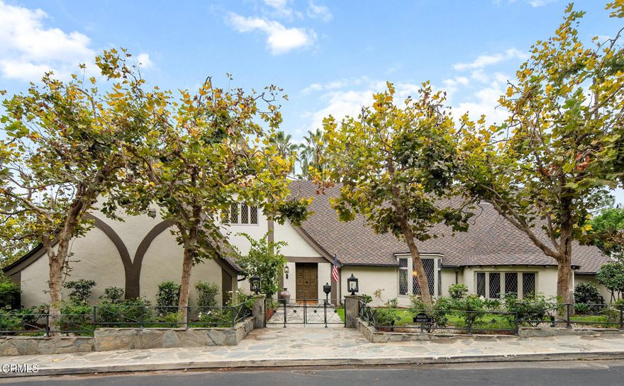 Welcome to Valley View cottage--a treasured piece of Pasadena's architectural heritage designed by Wallace Neff nearly a century ago. One of thirteen beautifully restored cottages on the gated grounds of the historic Huntington Hotel, Valley View was built in 1926 for the hotel's long-time owner and manager D.M. Linnard. Rich with timeless character, the residence blends Tudor Revival and storybook cottage styles with hints of a Grimmian fairytale. As you enter, striking interiors and design flourishes echo the home's impressive exterior. In the great room, a nearly 20' ceiling features exposed trusses and beams, creating a grand space for entertaining. The formal dining room glows with natural light from a thirty-foot wall with diamond-shaped mullioned windows while the beautifully updated eat-in kitchen connects to a sunlit breakfast room. Completing the main level, you'll find a guest bedroom / media room, three-quarter bath, and the luxurious primary suite with private balcony and spa bath. Upstairs, two bedrooms share a bathroom, with the southeast bedroom featuring a private balcony and sweeping valley views. The extremely versatile lower level, with its own entrance, offers a bedroom ensuite, two offices, a gym, two kitchens, and flexible living spaces. Outdoors, tiered gardens recall a countryside manor, equally suited for entertaining or a quiet evening under the stars in the Jacuzzi. With four deeded parking spaces plus a three-car garage, guests come and go with ease. As a resident of Huntington Circle, you'll enjoy direct access to the Langham Hotel's world-class amenities--from lush gardens to fine dining. Combining exquisite architecture, modern luxury, and unmatched convenience, Valley View invites you into a timeless storybook setting where your happily-ever-after unfolds.