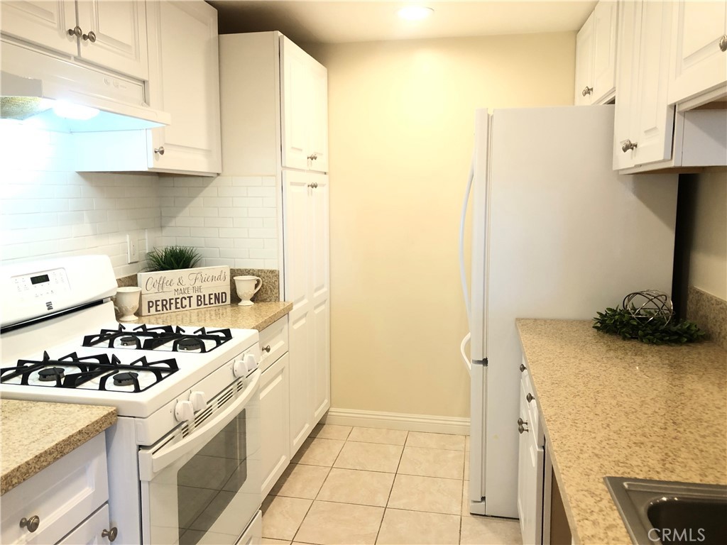 Lovely upgraded two bedroom one bath condo conveniently located in the beautiful City of Placentia, near the 55 FWY. This 853 Sq Ft condo has an upgraded kitchen with white cabinets, quartz counter tops, white gas stove, white refrigerator, stainless steal sink and tile flooring. The living room is spacious with recessed light, connected to the dining room, both with upgrading laminated flooring and dual pane windows. The bedrooms both have recessed lighting, dual pane windows and laminated flooring. The bathroom has a full tub, shower, upgraded gray and white granite counter top, dual pane window and white cabinets. There is a 1 car garage and extra parking all around the complex. You must see this beautiful home to full appreciate all the love invested!