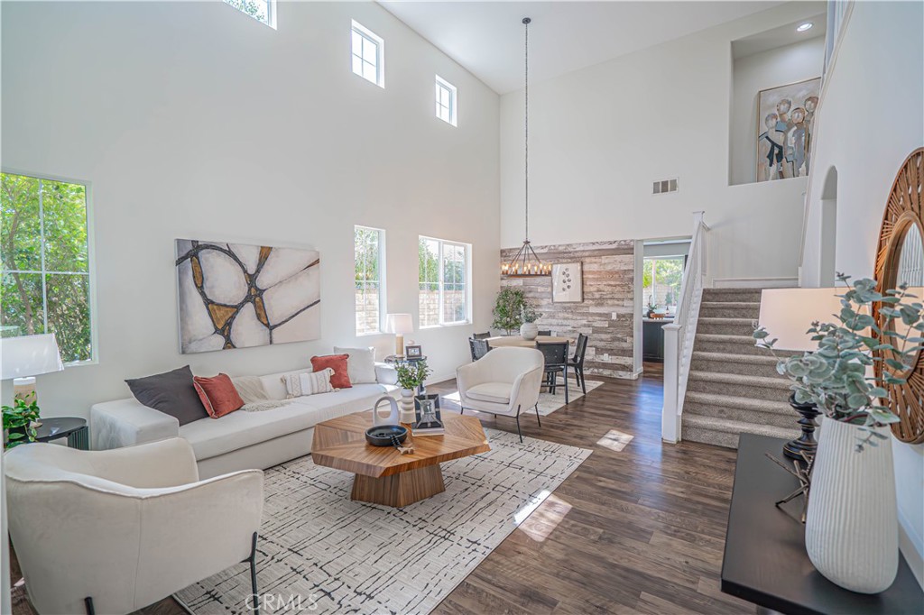 Welcome to Rustico Court in The Ranch at Tesoro Del Valle—one of Valencia’s most sought-after neighborhoods! Located on a quiet cul-de-sac with the second-largest lot on the street, this spacious home offers nearly 3,020 sq ft, 5 bedrooms, and 3 full bathrooms, including a full bedroom and bathroom on the main level—ideal for guests, multi-gen living, or a home office. Freshly painted inside and out—this home is move-in ready! The remodeled kitchen is a chef’s dream with quartz countertops, KitchenAid appliances, and 4 ovens (double oven, oven/range combo, and built-in Advantium microwave). Custom dark alder wood cabinets provide exceptional storage with soft-close doors and drawers. Additional highlights include ,Engineered hardwood flooring throughout both levels, Fully remodeled downstairs bath with added shower, Huge primary walk-in closet with brand-new carpet, Extra flooring included for optional primary bath upgrade. Pool-sized backyard ready to customize for your dream outdoor space, 33-panel SunPower solar lease at just $287/month, keeping electric bills low,Low Mello-Roos tax. The Tesoro HOA offers some of the best amenities in Santa Clarita for just $189/month, including:Private lake & clubhouse, Olympic-sized lap pool, huge kids’ pool, and 2 hot tub, Fitness center, outdoor kitchens, and picnic areas, Parks, playgrounds, basketball, tennis, and sand volleyball courts, Baseball & soccer fields, Horse, bike, and hiking trails, Walk or bike to top-rated schools (Tesoro Del Valle Elementary, Rio Norte Jr. High, and Valencia High) and enjoy easy access to shopping, dining, and the 5 freeway. Don’t miss this rare opportunity to own in one of Southern California’s premier communities—Rustico Court is calling you home!