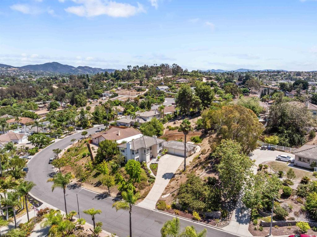1957 Cresthaven Drive is all about the San Diego lifestyle. Situated on an elevated lot in a quiet cul-de-sac, this 4-bedroom plus office, 3-bath home offers stunning views and refreshing breezes. Step inside to find fresh interior paint, updated carpet, and beautifully remodeled bathrooms (2025). The kitchen and baths feature quartz and granite countertops, while wood-look tile floors and modern fixtures add a polished touch. Cozy fireplaces warm both the living and family rooms, and central heat with dual zone AC and ceiling fans keep the home comfortable year round. The spacious primary bedroom has plenty of room for seating and an en-suite bath with shower and separate soaking tub, dual sinks and a walk-in closet with organizers. This home features an OWNED SOLAR system (2022), replaced roof underlayment 2022, dual EV charging ports and a recently added office with French doors leading to a private patio - perfect for working from home. The large laundry room includes a new washer and dryer set (Aug 2025). Outdoors, enjoy the large, landscaped yards, which offer space for a pool, RV parking, or even a pickleball court. Located just 20 minutes from Oceanside, Carlsbad Village and the Pacific Ocean, this home offers the best of Southern California. Neighborhood amenities include access to fresh local produce direct from growers, local breweries, a beautifully revived Downtown Vista, and quick trips to Fallbrook and Temecula wineries. Outdoor enthusiasts will appreciate the close proximity to walking and biking trails, including the San Luis Rey River Trail, which extends to the ocean, and the Rail Trail to Escondido. Nearby Guajome State Park offers hiking, horseback riding trails, duck pond and catch-and-release fishing. Walking distance to Guajome Park Academy (K-12), or cycle through the park to top-rated Mission Vista High School (10/10). This home is truly designed for the SoCal lifestyle—sunshine, relaxation, and adventure at your doorstep.