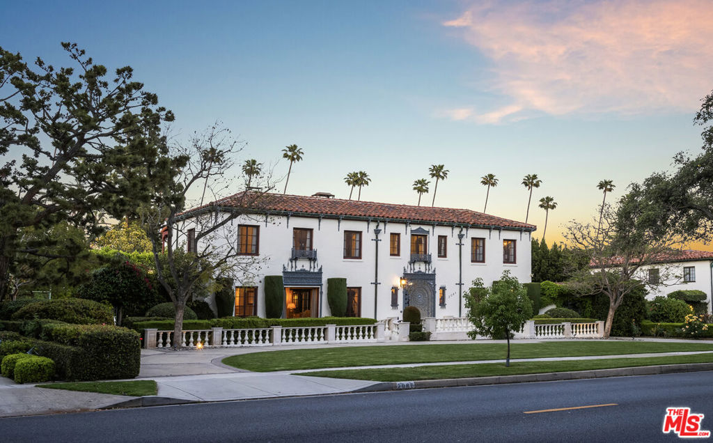 Designed in 1928 by renowned architect Emmet Martin, this stately palazzo was modeled after the Medici villas and featured in Architectural Digest just a year after it was built. The home blends old-world elegance with modern amenities and a practical floor plan. Originally commissioned by the owners of the Kay-Brunner Steel Casting Company, the property showcases stunning architectural craftsmanship: original wrought ironwork, a handmade entrance gate, chandeliers, sconces, carved wooden doors, ornamental steelwork, and hardwood floors all beautifully preserved and thoughtfully integrated throughout. A grand foyer and sweeping spiral staircase lead into an elegant living room with a classic marble fireplace and French doors that open onto a spacious terrace with its own fireplace perfect for romantic California evenings and seamless indoor-outdoor entertaining. The formal dining room features dramatic wrought iron lighting and connects to a chef's kitchen equipped with Thermador and Viking appliances, an oversized center island with breakfast bar, and a walk-in pantry. Adjacent to the kitchen is a casual living area, with a staircase leading down to a storage basement. Completing the main level are a guest bathroom with pool access, a laundry room, and a large bedroom suite. Upstairs, a spacious landing opens to four-bedroom suites. The primary suite includes a walk-in closet, dual vanity, shower, spa tub, and a private office area that leads to a tranquil balcony. A separate terrace provides the perfect spot for morning coffee or enjoying the Lacy Park July 4th fireworks. The beautifully landscaped grounds include a fireplace lounge, lighted paddle tennis/sports court, heated pool and spa, lush gardens, a fountain, a two-car garage, and a circular driveway with ample parking. Ideally located near Lacy Park, the Langham Hotel, and the Huntington Library, this exceptional home is also within the award-winning San Marino school district. NOTE: Tax assessor shows property as 4BR plus downstairs family room.