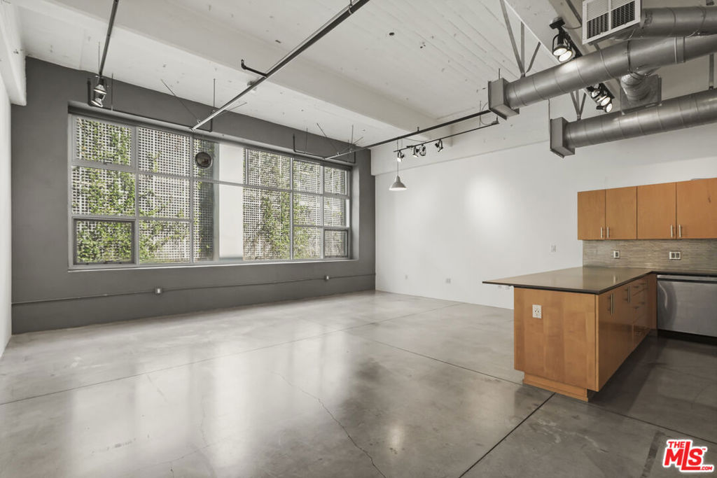 Authentic industrial live/work loft at the legendary Flower Street Lofts in south park, downtown's most vibrant and trendiest neighborhoods. 1 bedroom/ 1.5 baths, in unit washer & Dryer. 2 reserved parking spaces (not tandem). Open loft with expansive windows, soaring exposed 14' ceilings, concrete floors, gourmet kitchen, with newer stainless steel appliances. Master bath remodeled with new vanity and stone tiled bath/shower and designer fixtures. LARGE walk in closet. Pre-wired for high speed internet and cable access. This loft home can ideally be used as both a corporate office and/or a home. Neighborhood amenities incl. Pine & Crane, South Park Grocery & Pharmacy, Orange Theory Fitness, Starbucks, Prank Bar, Hygge Bakery, King Cigar Lounge, IVLA, Tooth Shop, Healthy Spot... and moments from Ralph's, Whole Foods, Crypto.com Arena, LA Live, Ritz-Carlton, upcoming Oceanwide Plaza & Park Hyatt, Regal Theaters, and all of DTLA's hot spots. Come home to Flower St Lofts, a piece of living history that exemplifies the burgeoning community of art, culture, and entertainment in downtown. Rent includes Parking, Water, Sewage, Trash, Parking, TV (HBO & Showtime) + Internet. *Tenant pays electricity separately and will be required to carry renters insurance for duration of the lease.